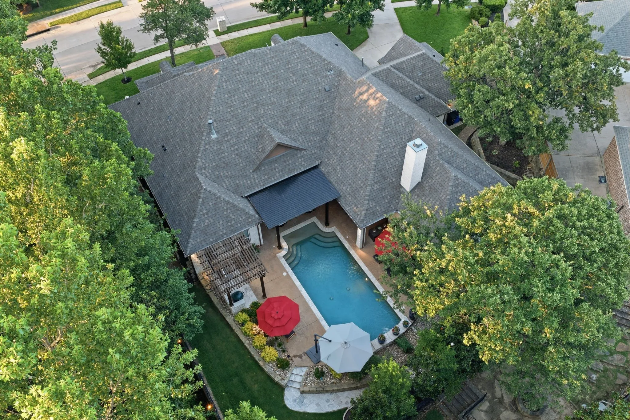 Private backyard swimming pool, attached covered patio, and a pergola-covered spa area.
