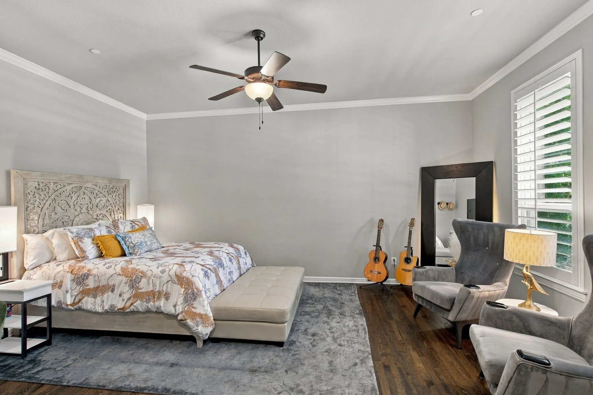 Spacious third bedroom privately situated on its own hallway, separate from both the primary suite and additional guest bedroom. Rich hardwood floors, plantation shutters and room for a comfortable sitting area create an inviting retreat, while a walk-in closet provides generous storage. Convenient access to a nearby full bath completes this well-planned private wing.