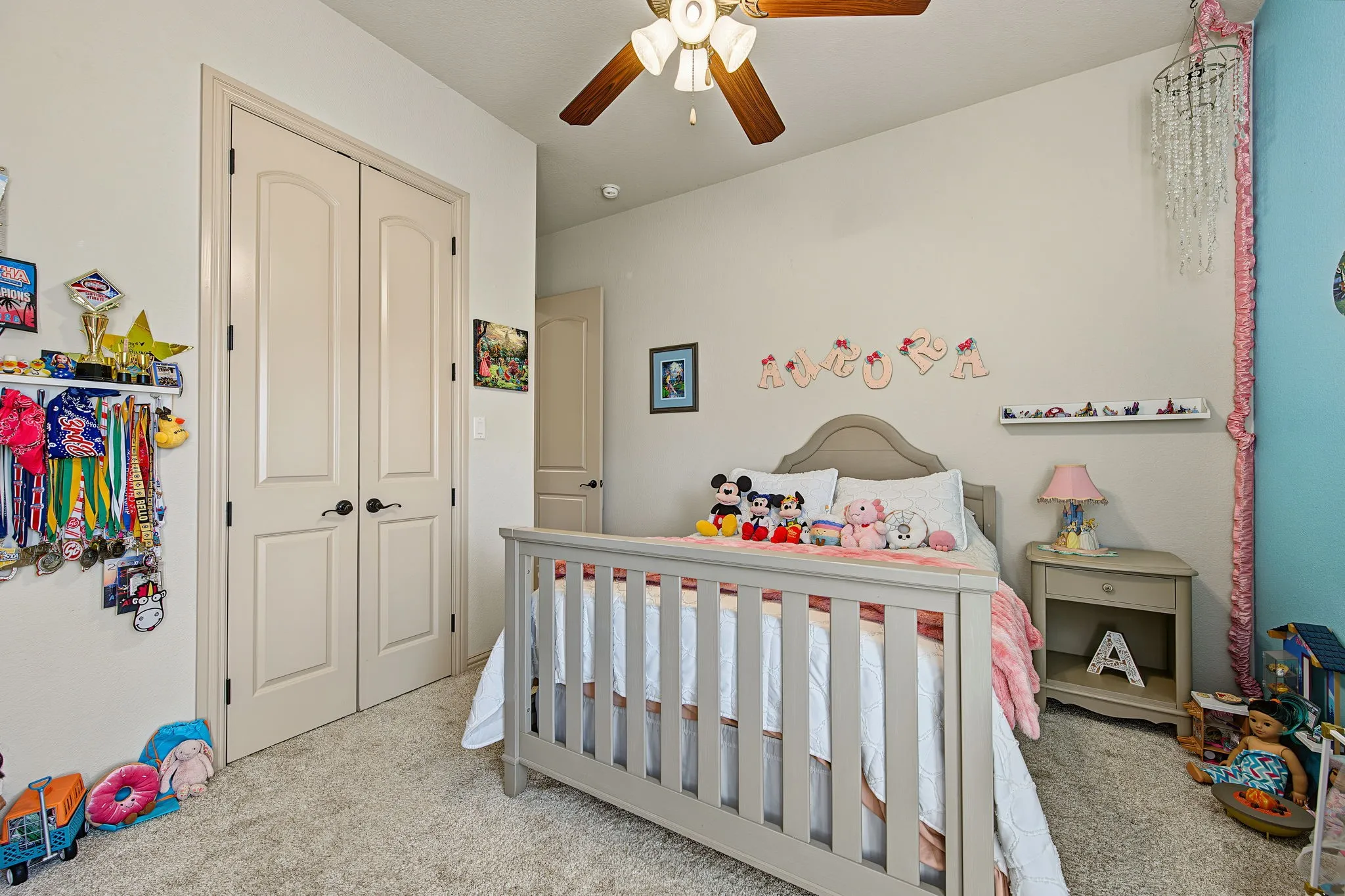 Recessed ceiling light, ceiling fan, and carpeted flooring