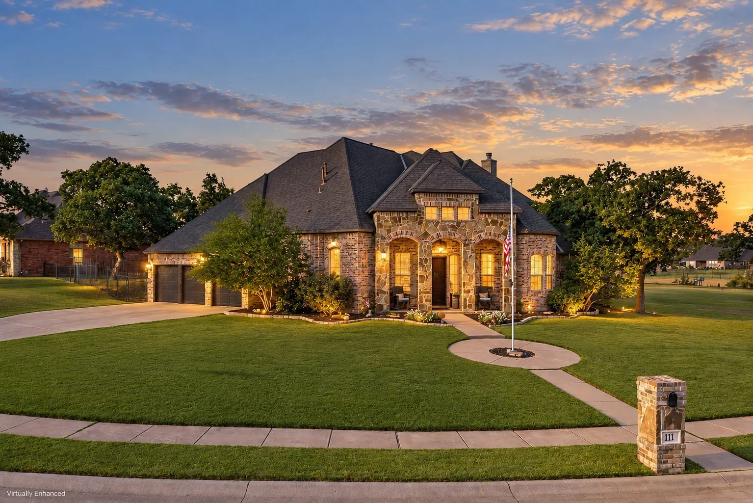 Virtually enhanced twilight view of 111 Highland Court in Boyd, TX, showcasing the home’s impressive brick and stone exterior, architectural details, mature trees, expansive front lawn, and welcoming covered entry.