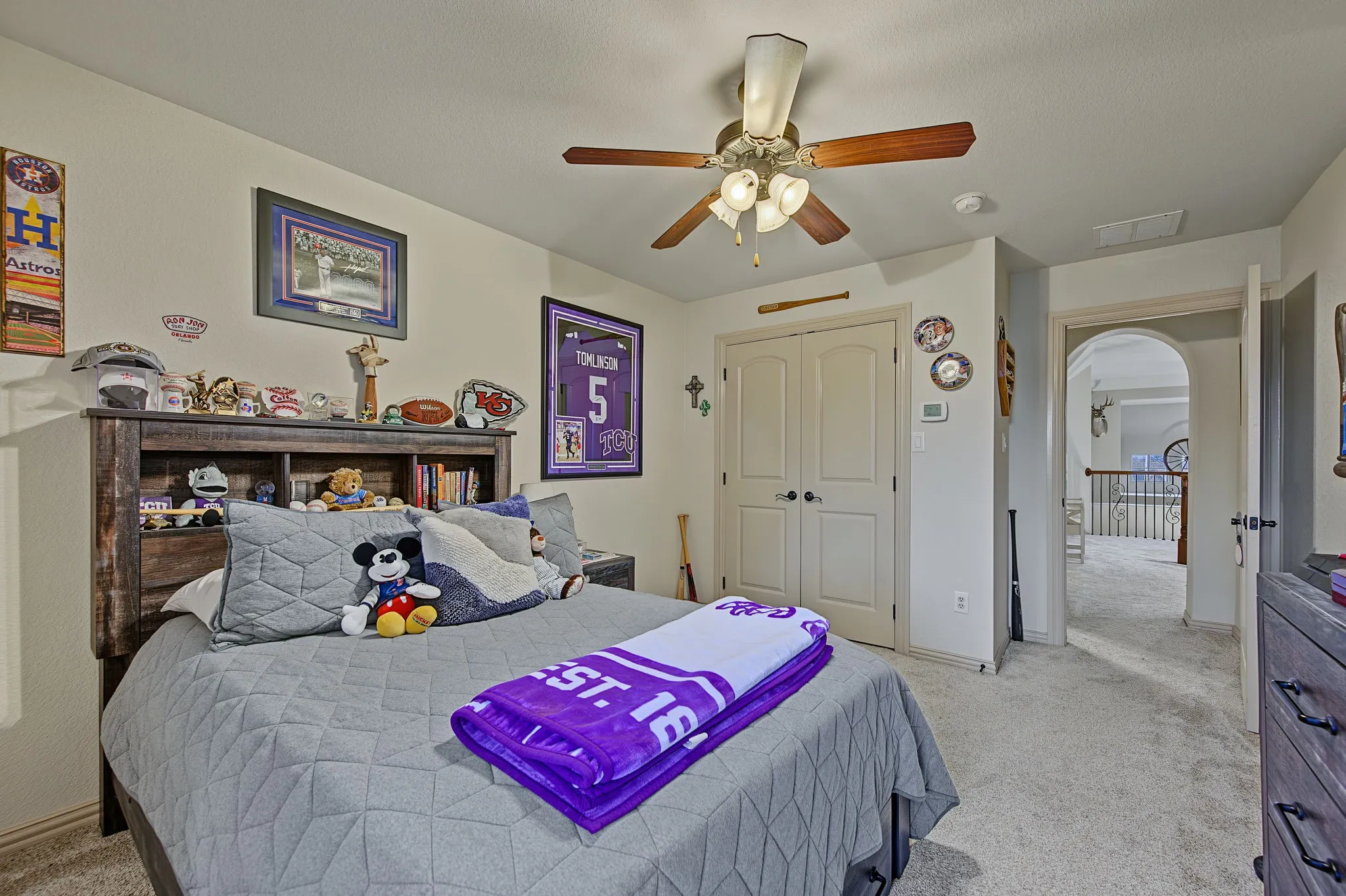 Recessed ceiling light with a ceiling fan, light-toned carpeting, and a built-in closet with double doors