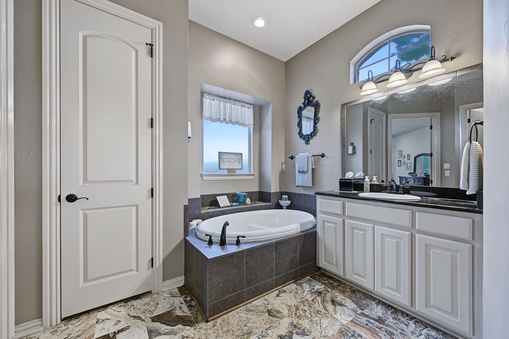 Spacious primary bath provides a comfortable ensuite retreat with well-planned storage and everyday functionality.