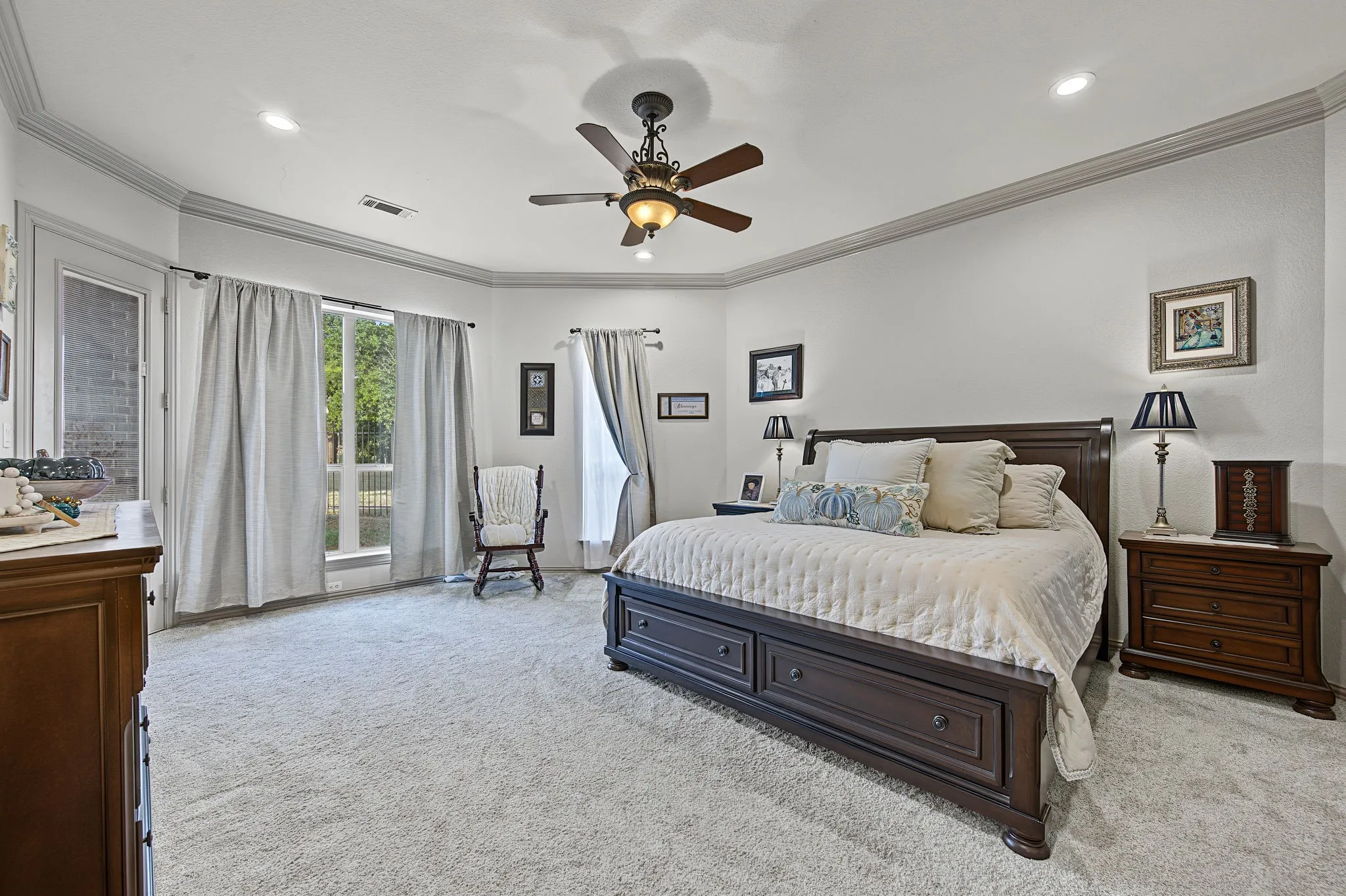 Private downstairs primary suite offers generous proportions and convenient separation from the home’s secondary living spaces.