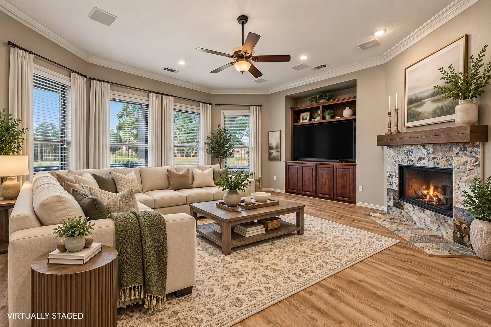 Virtually staged with modern transitional  furniture. Spacious living area featuring wood-finish flooring, a ceiling fan, and crown molding