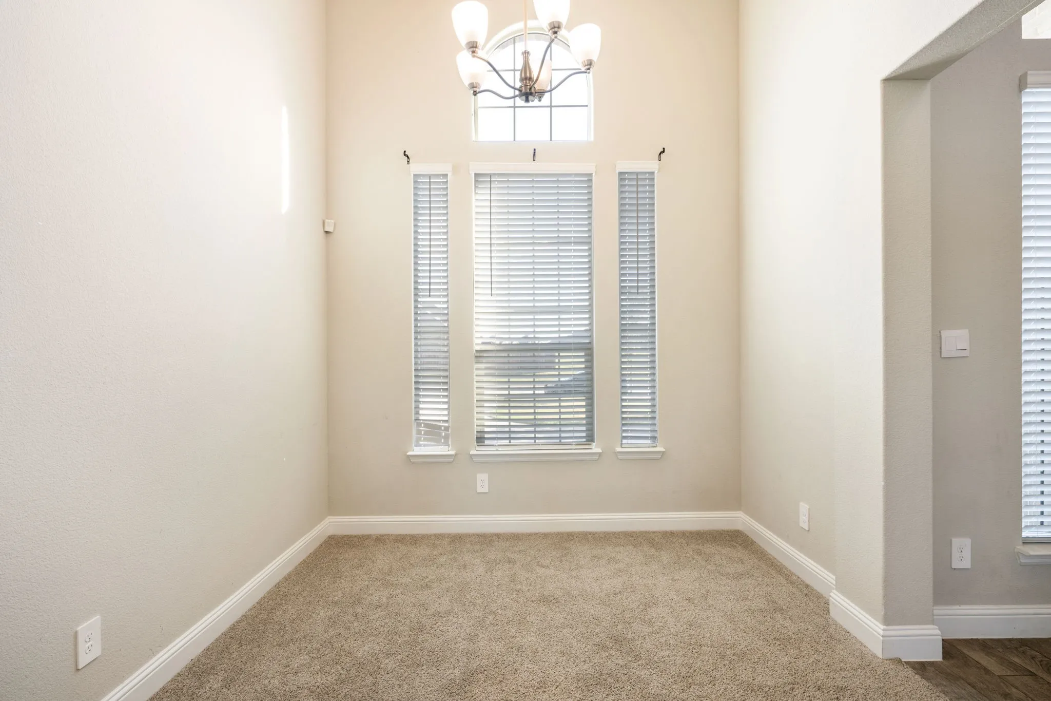 Tall ceilings with a decorative chandelier