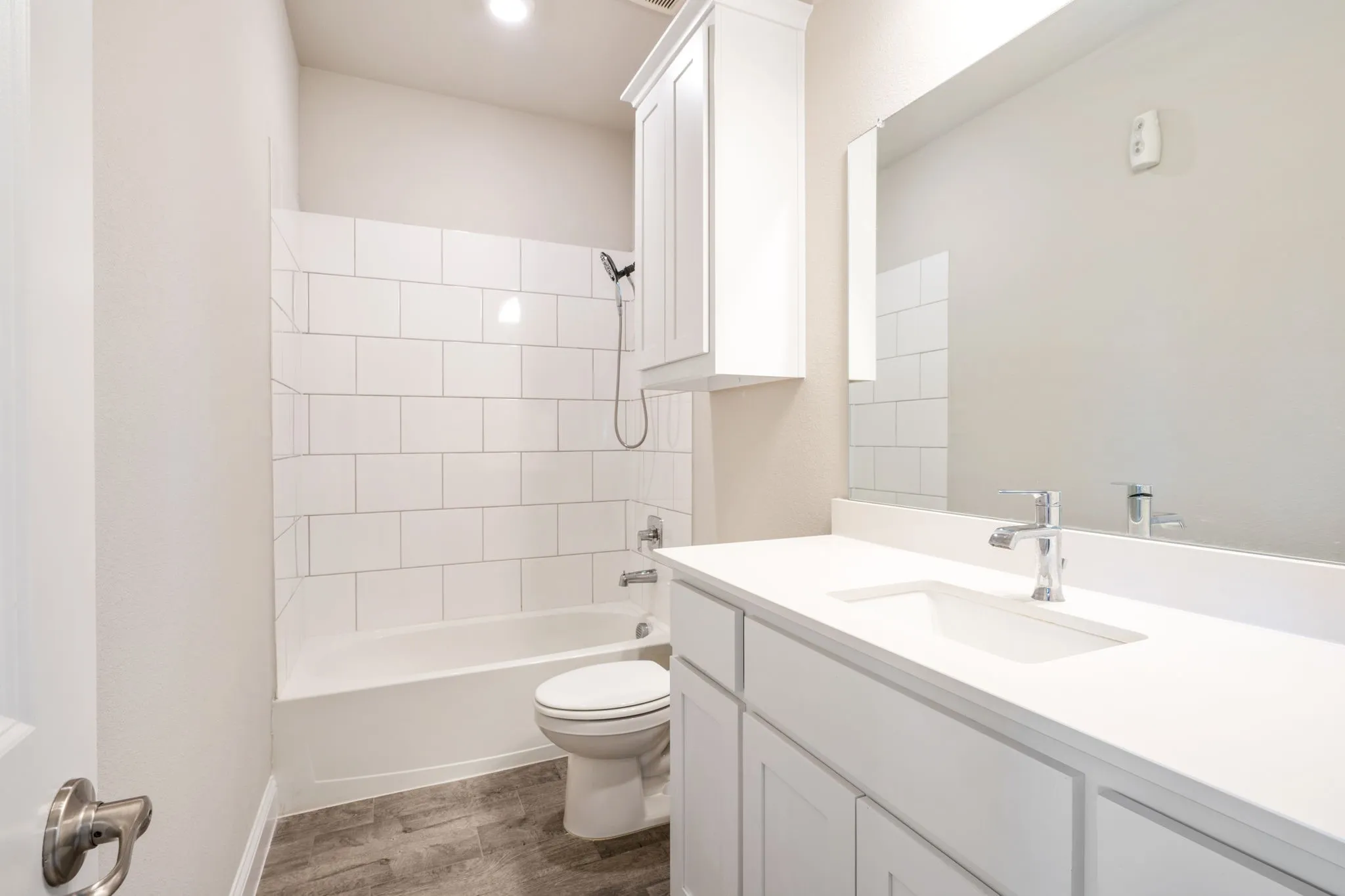 White subway tile shower surround with a built-in tub