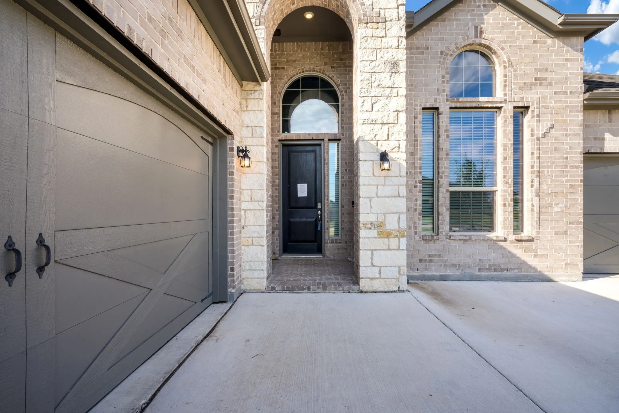 Brick and stone facade with an arched entry
