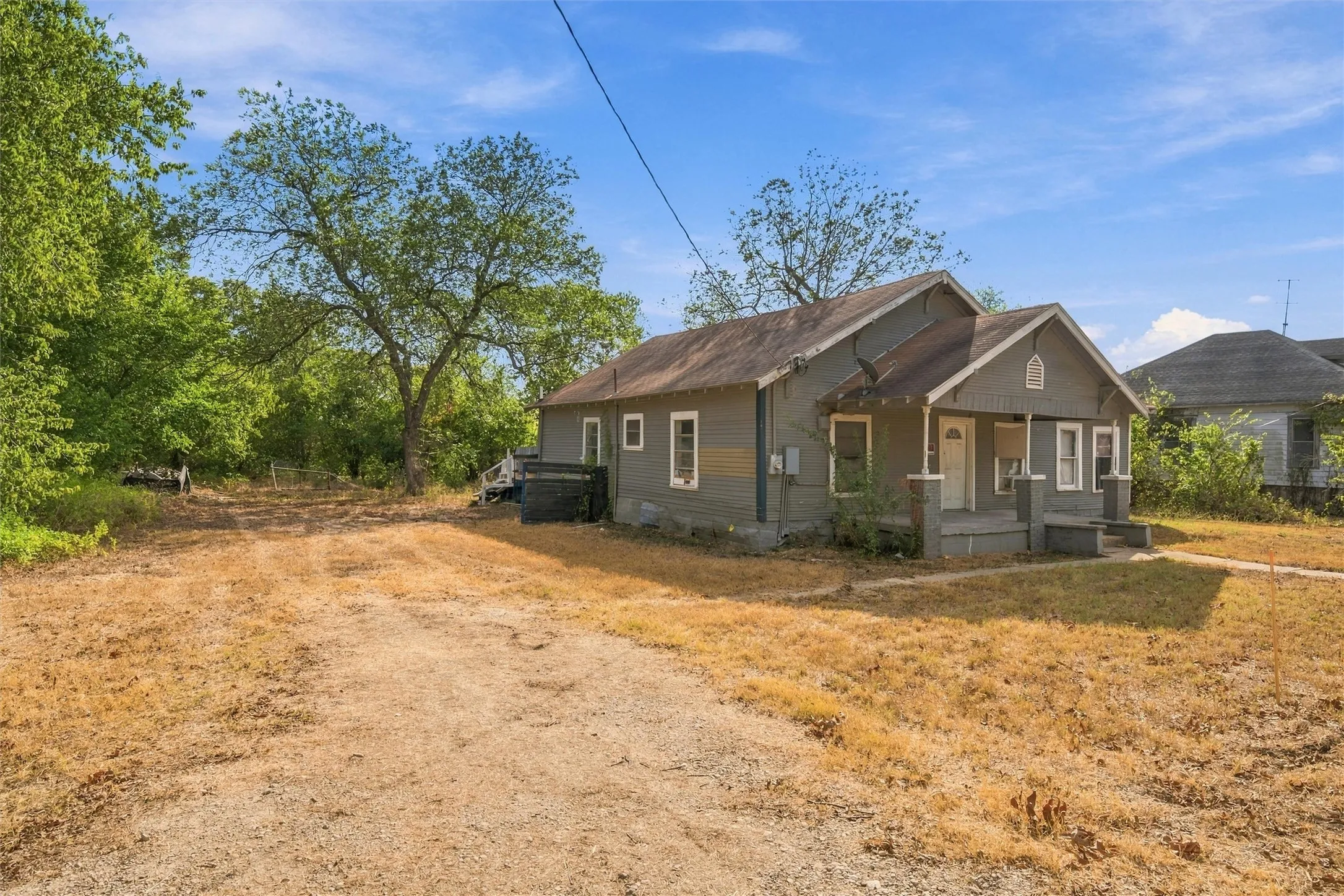 Single-story home featuring a covered front porch and exterior siding