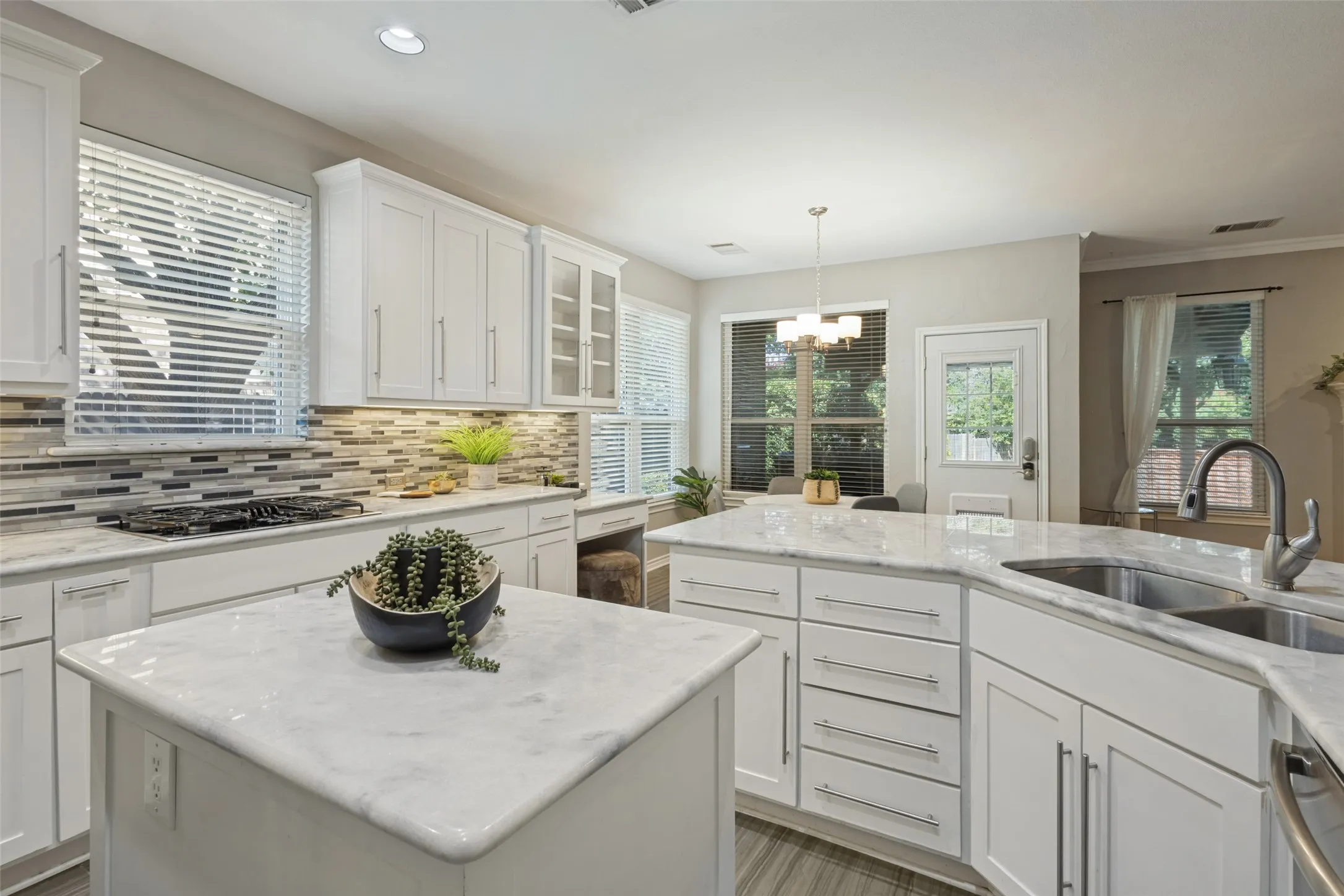 Gorgeous granite and white cupboards are finished with contemporary hardware. The gas cook to is a bonus!