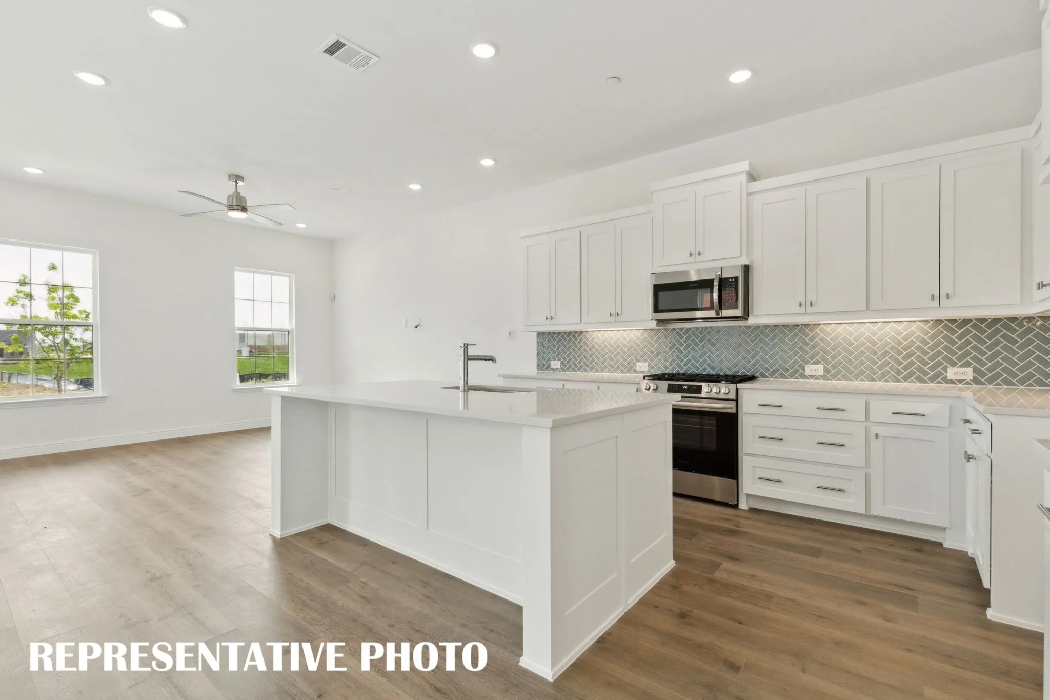 The spacious kitchen island is the perfect place for friends and family to gather!  REPRESENTATIVE PHOTO