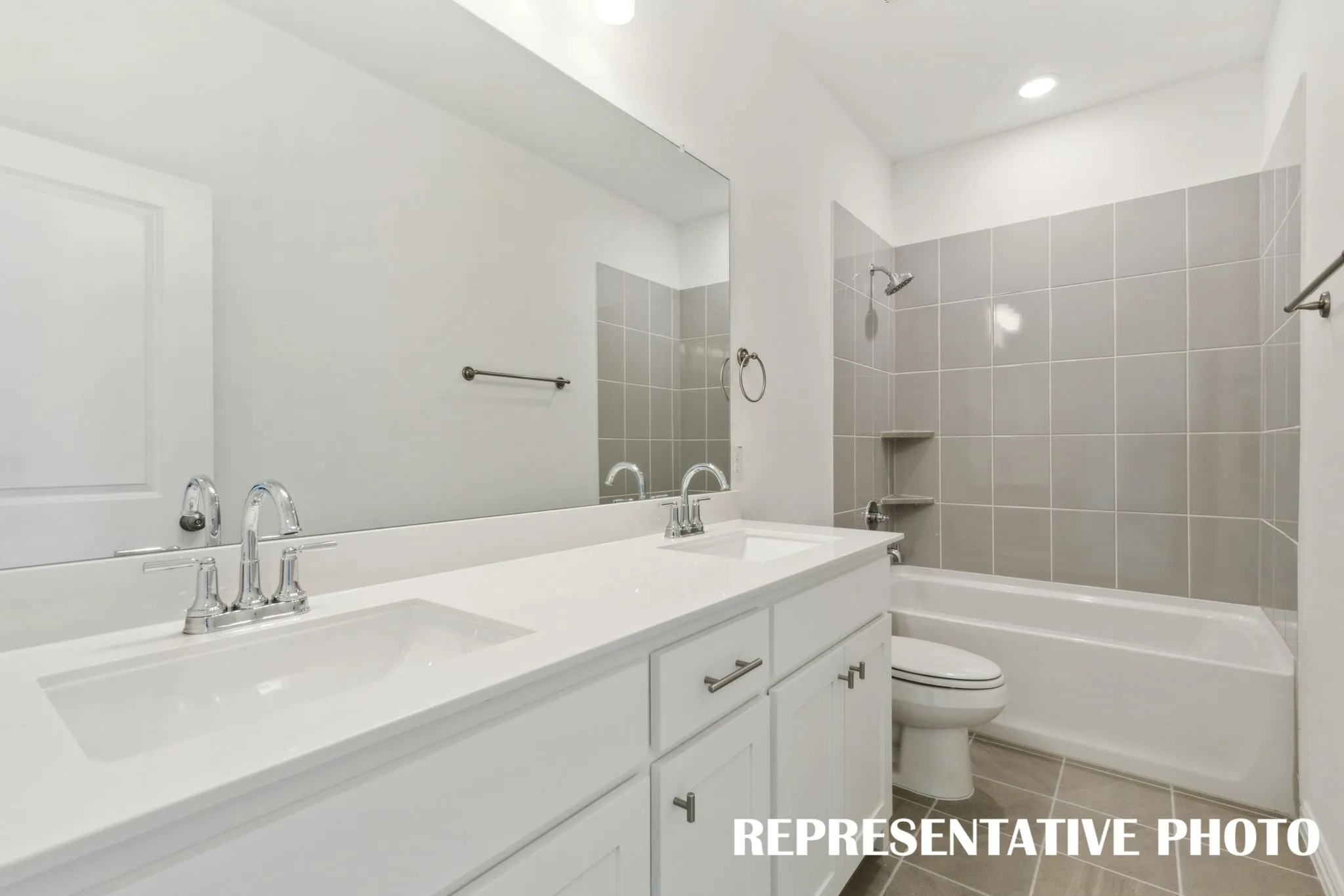 Featuring dual sinks, guests will enjoy their own space in this lovely bath.  REPRESENTATIVE PHOTO