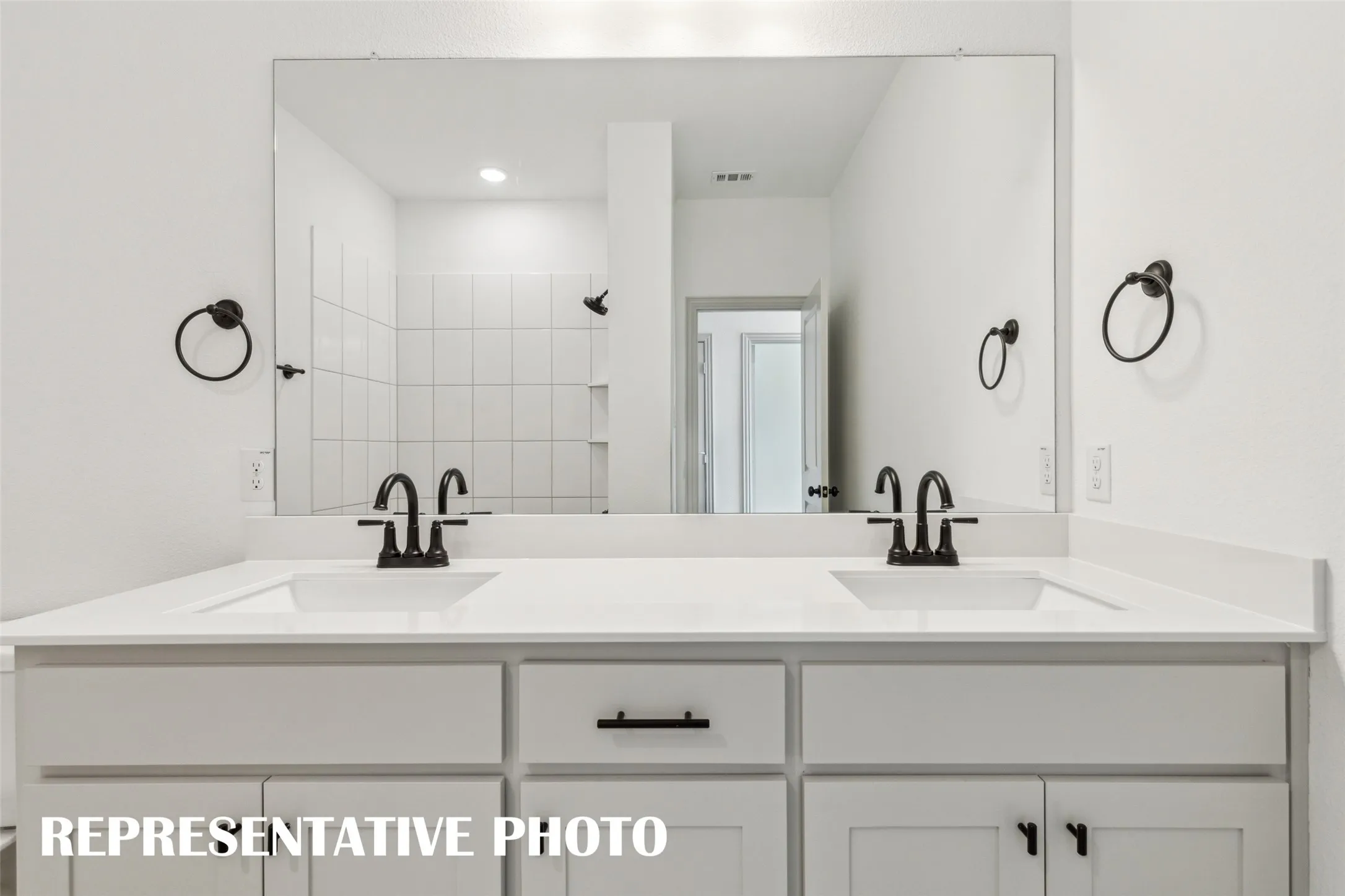 Guests will enjoy their own vanity space in this lovely guest bath.  REPRESENTATIVE PHOTO