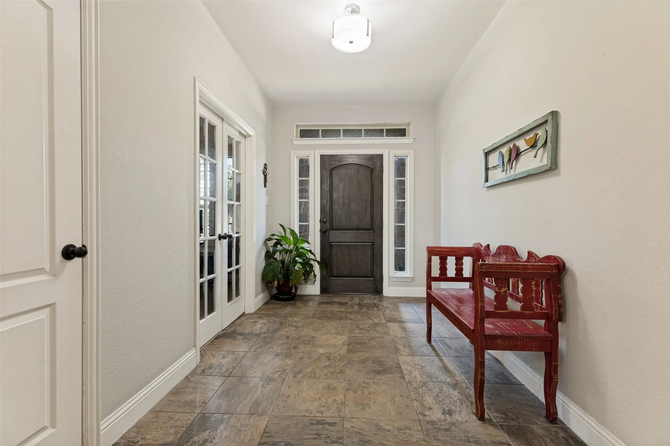 Entryway leading into living room and kitchen