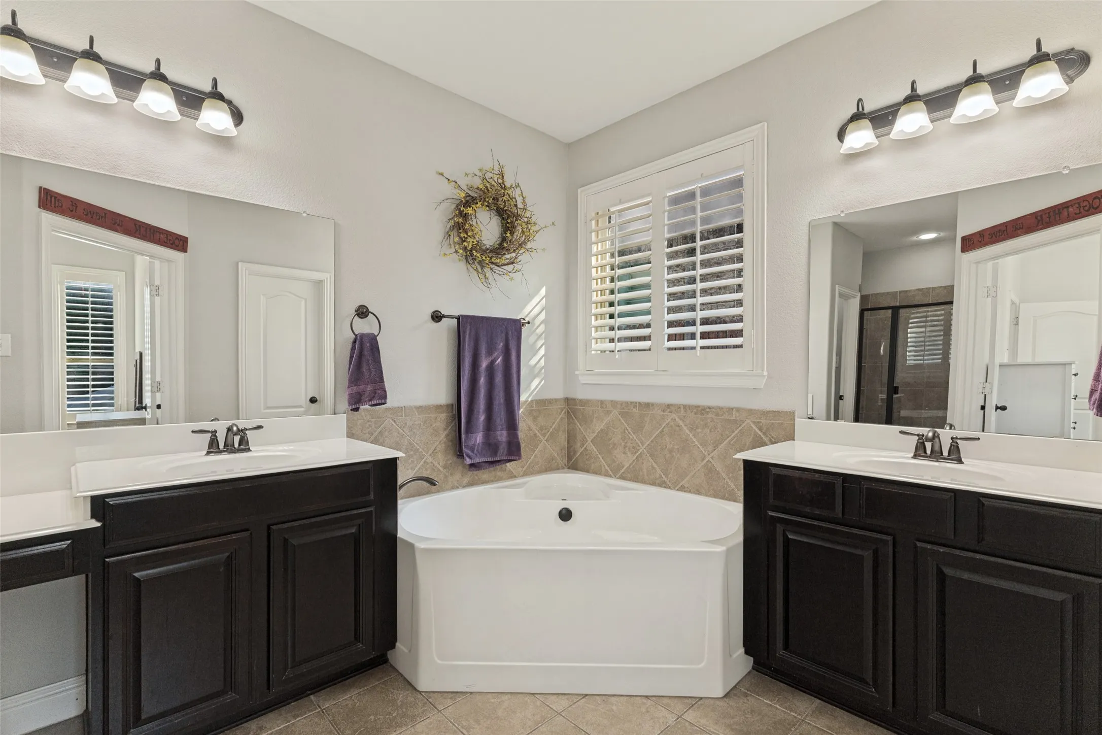 Primary bathroom with garden tub and double vanities.