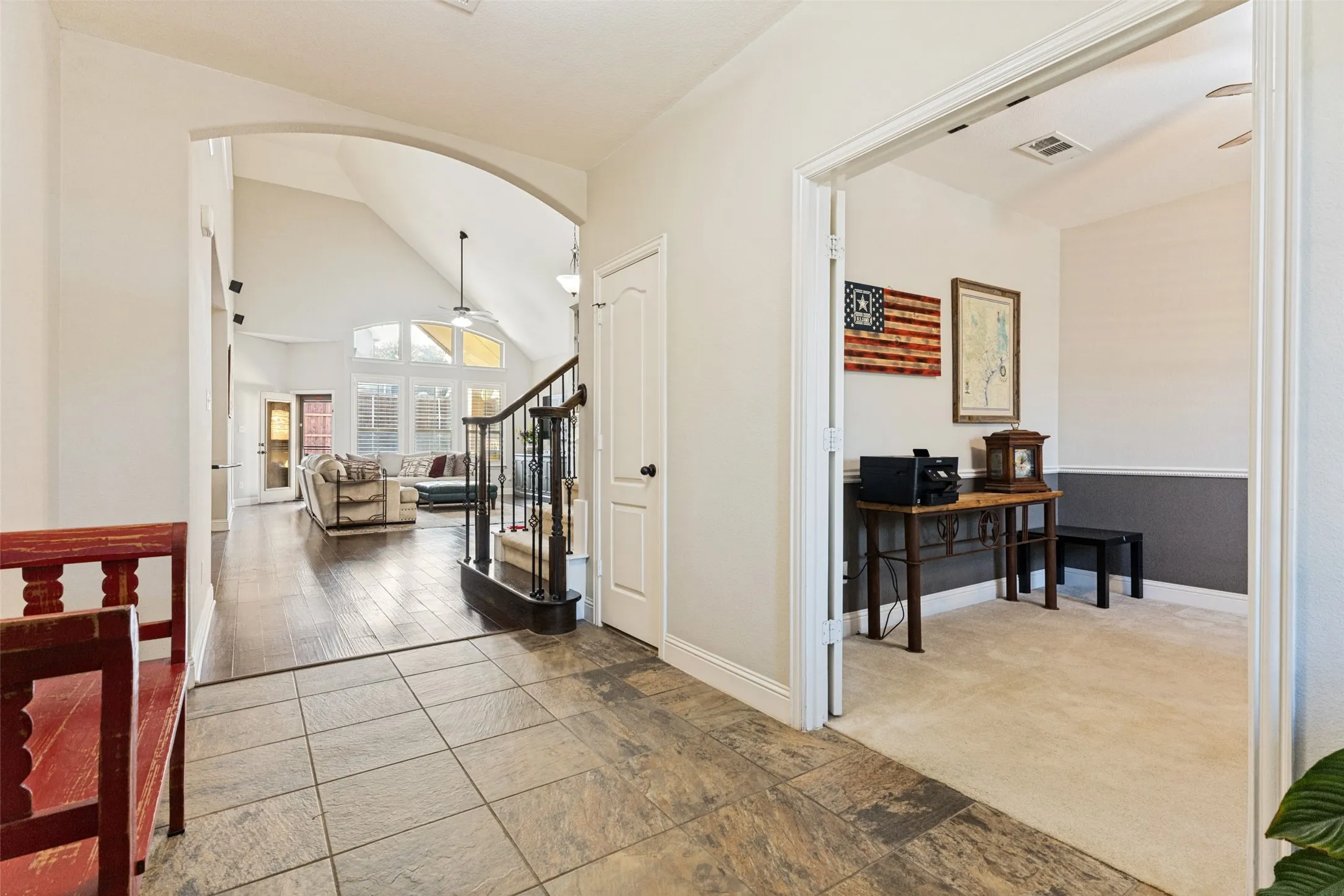 Entryway with office and view of living room