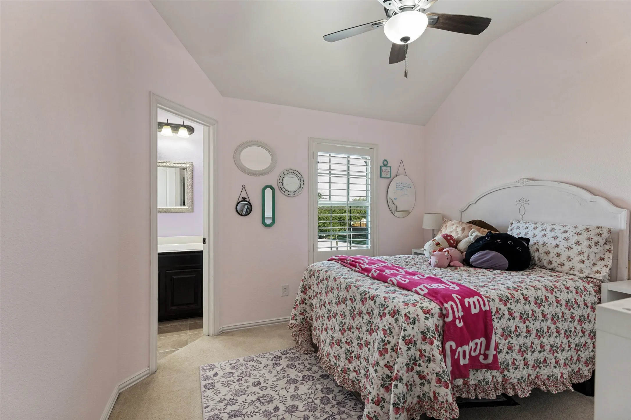Bedroom with ceiling fan, window, beige carpet and jack and jill bathroom