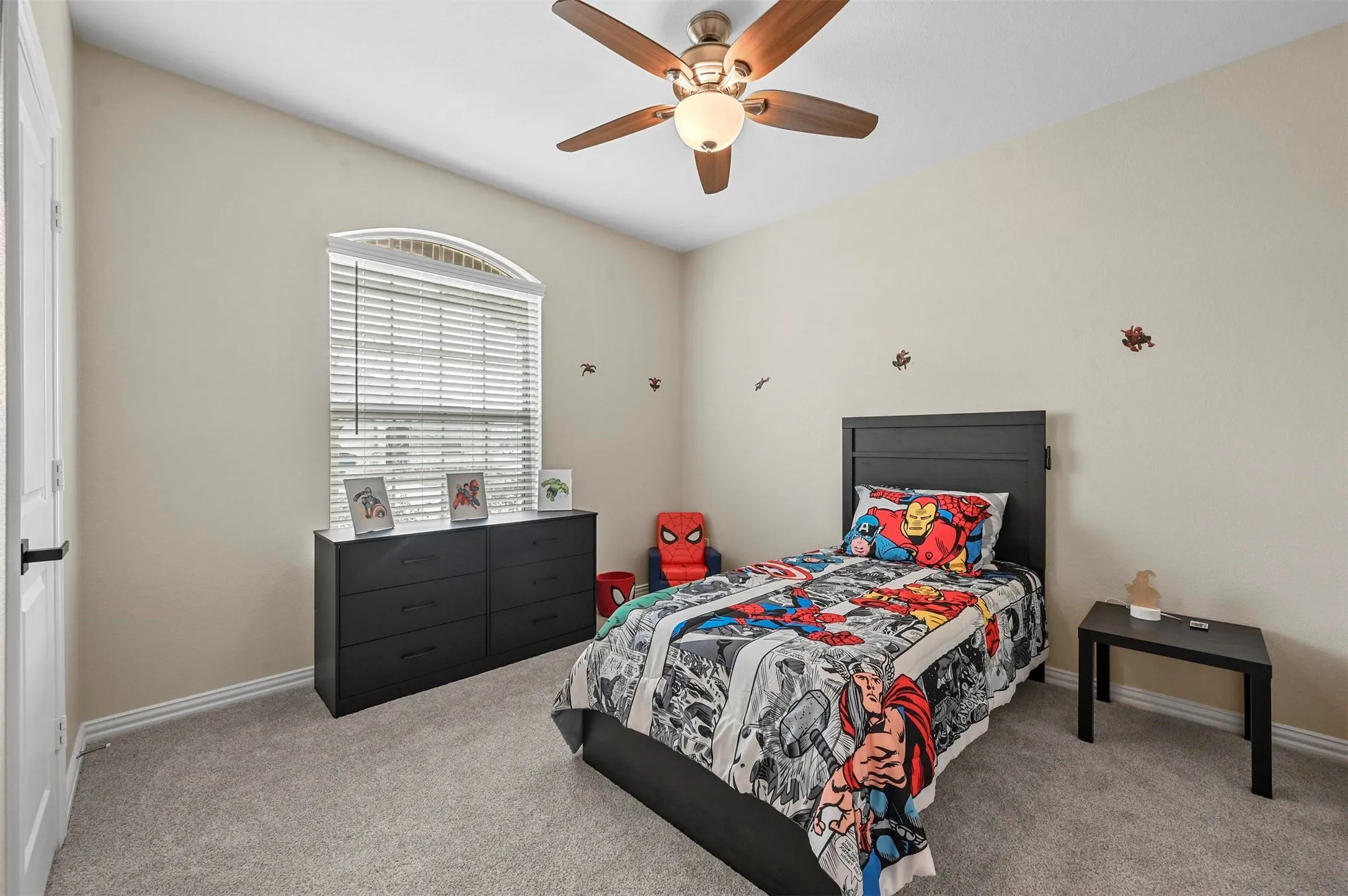 Bedroom with ceiling fan and light carpet