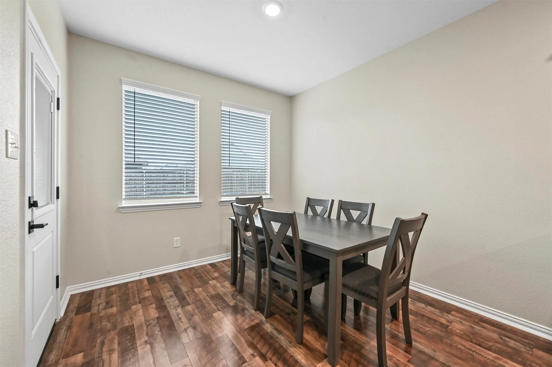 Dining space with dark hardwood / wood-style floors
