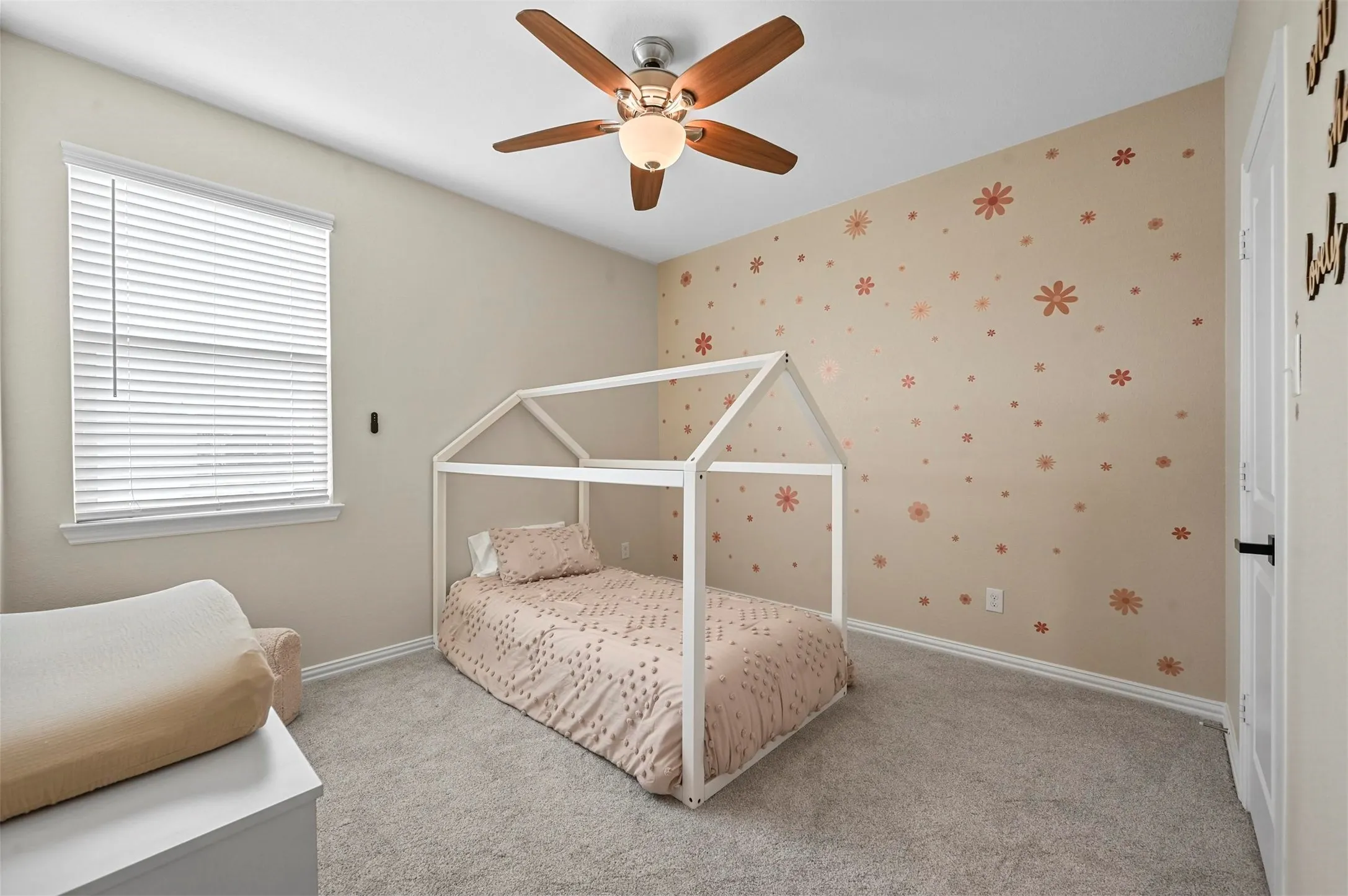 Carpeted bedroom with ceiling fan