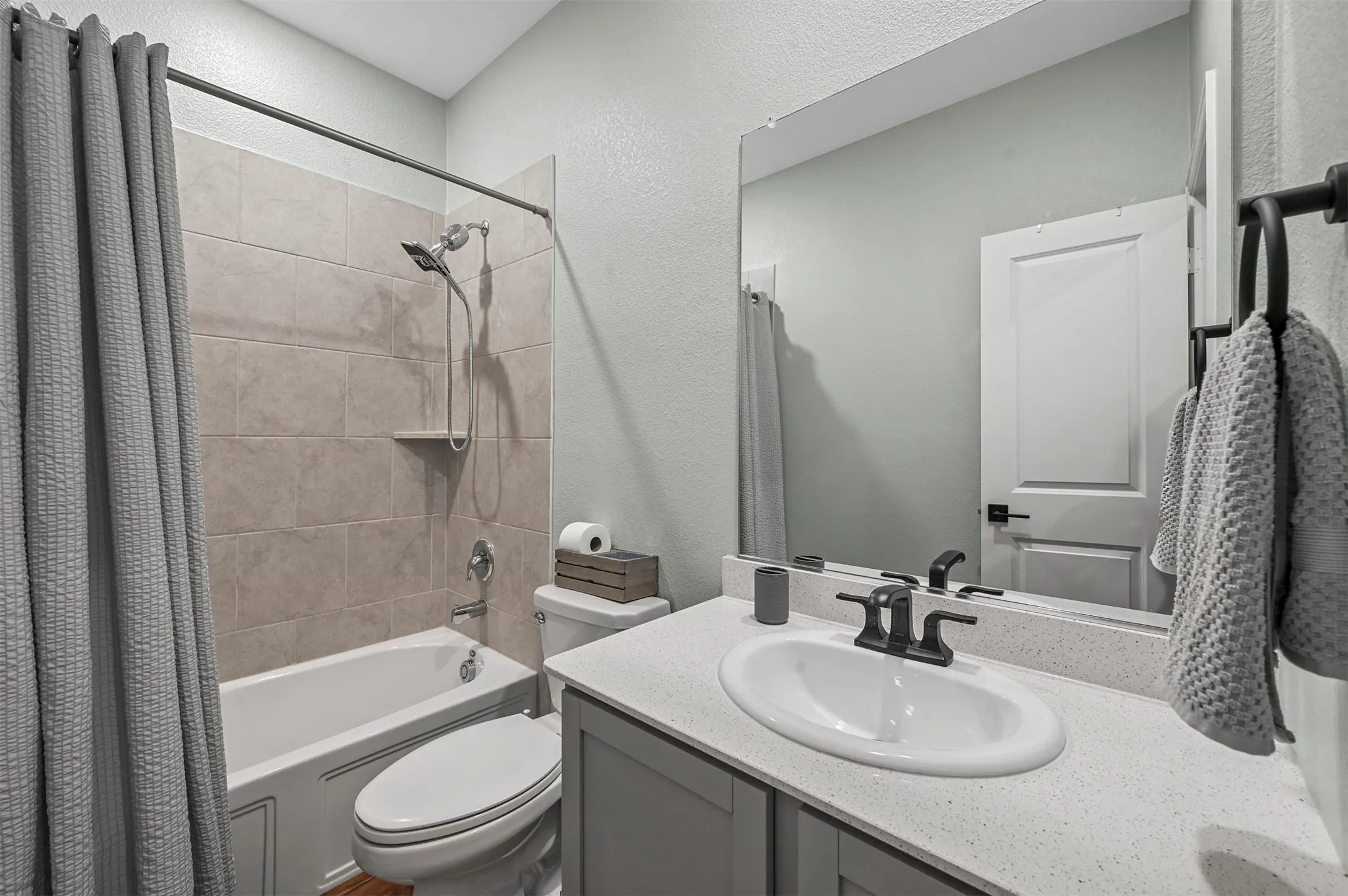 Full bathroom featuring shower / tub combo, vanity, and toilet