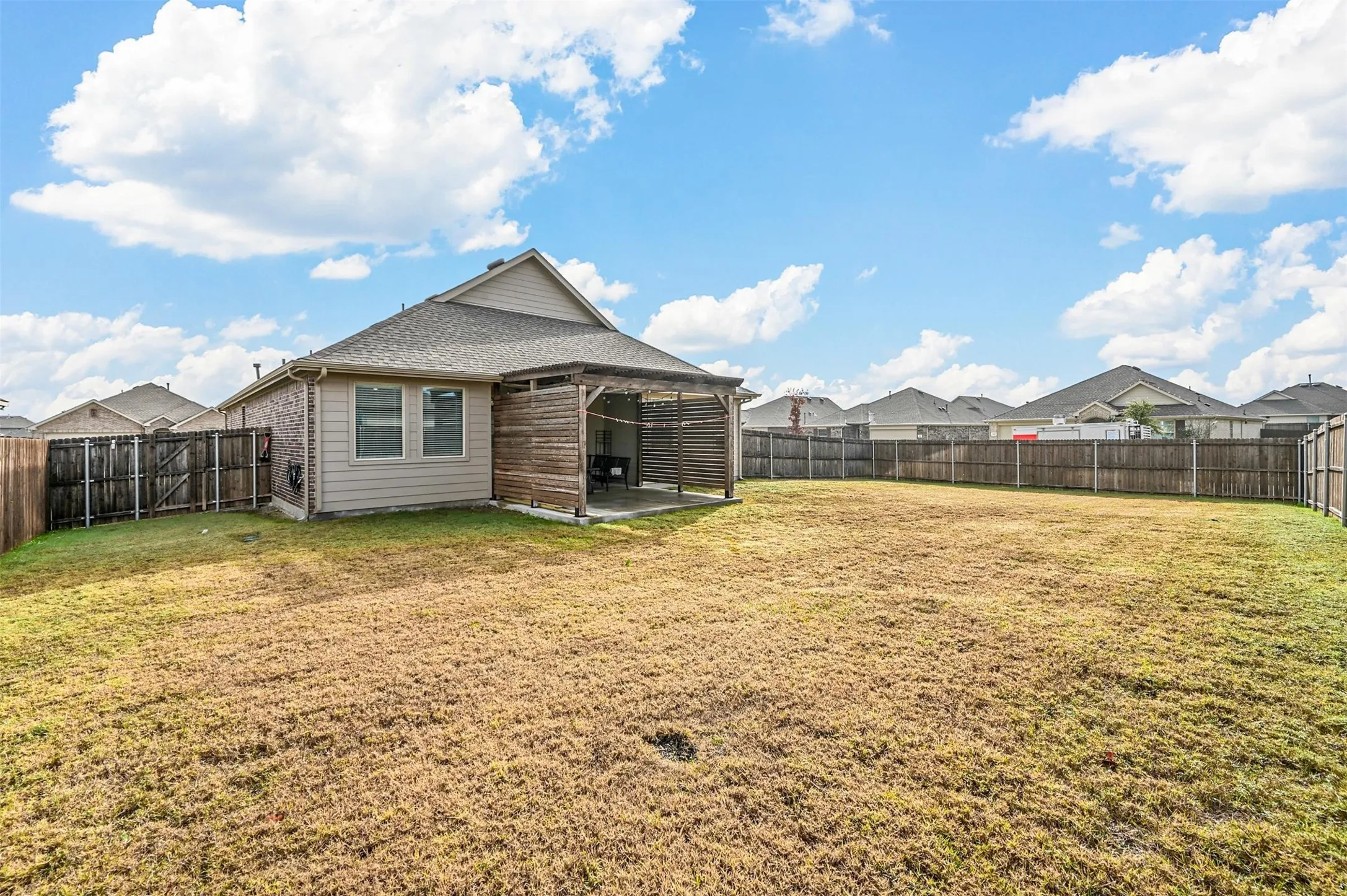 Rear view of property featuring a patio area and a lawn