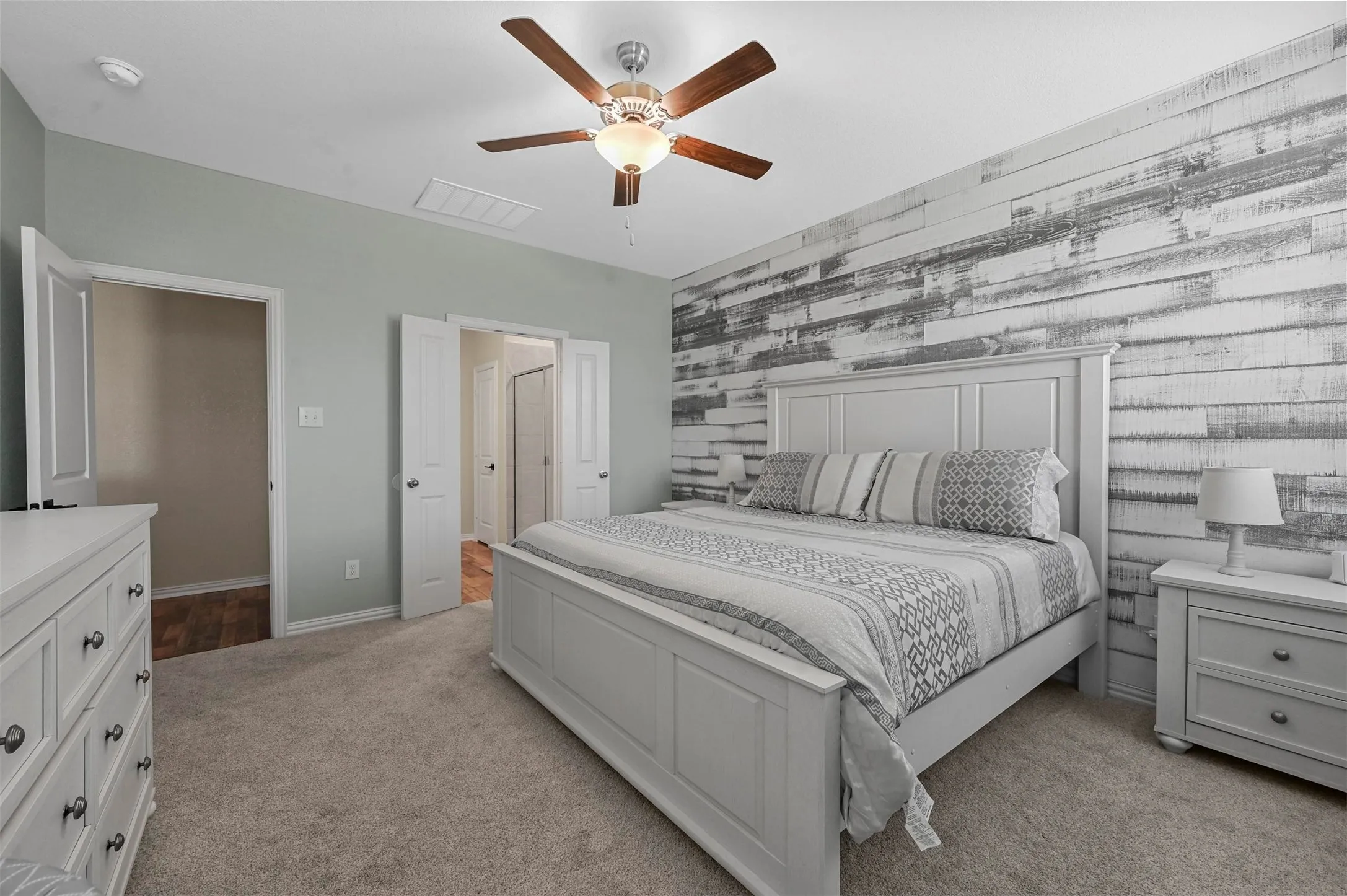 Bedroom featuring light carpet and ceiling fan