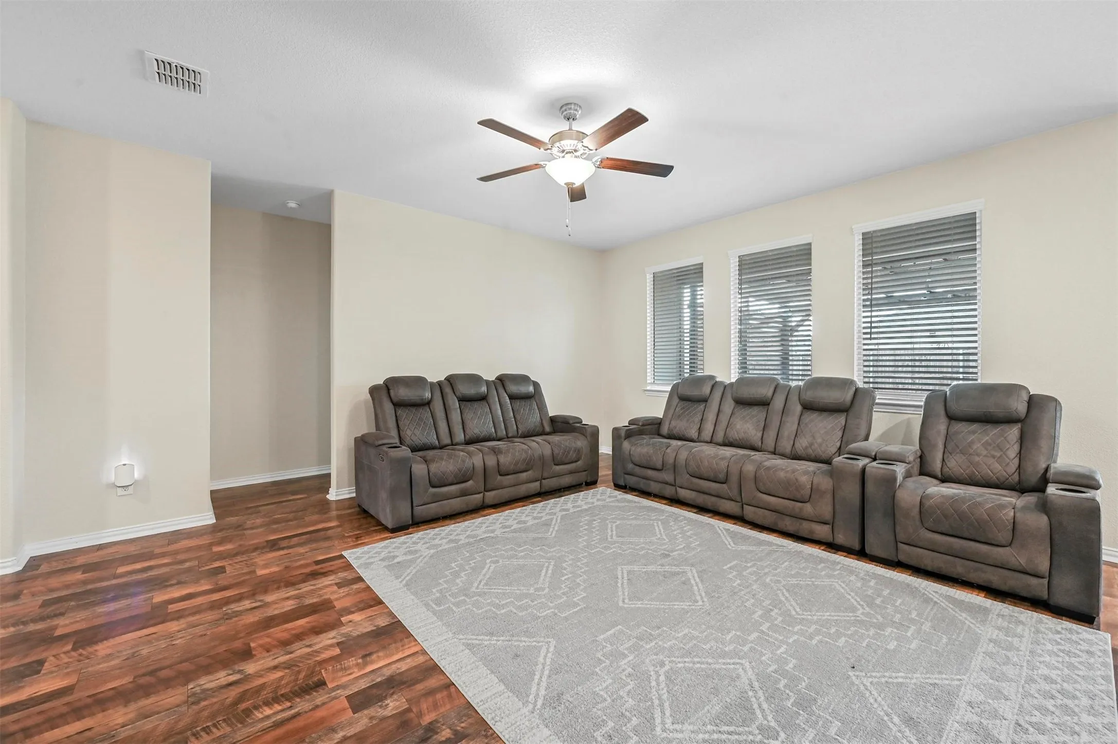 Living room featuring ceiling fan and dark hardwood / wood-style flooring