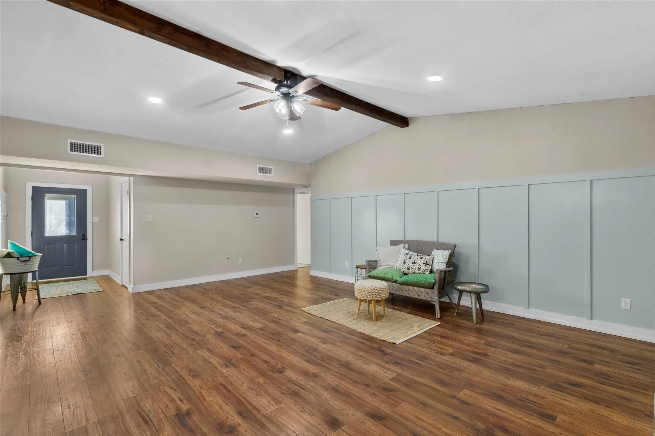 Vaulted ceiling with exposed wood beams, wood-finish flooring, recessed lighting, and a ceiling fan