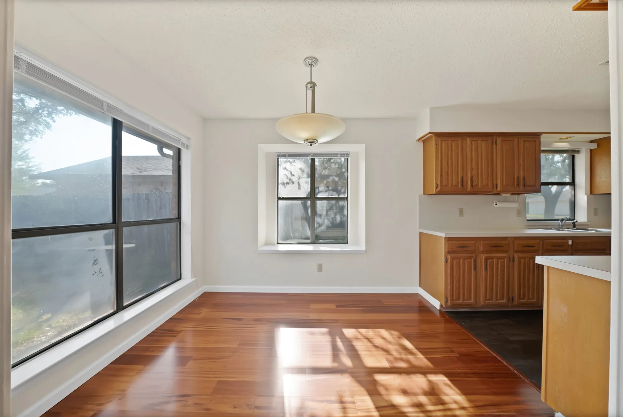 Wood-finish flooring, recessed window, and pendant light fixture