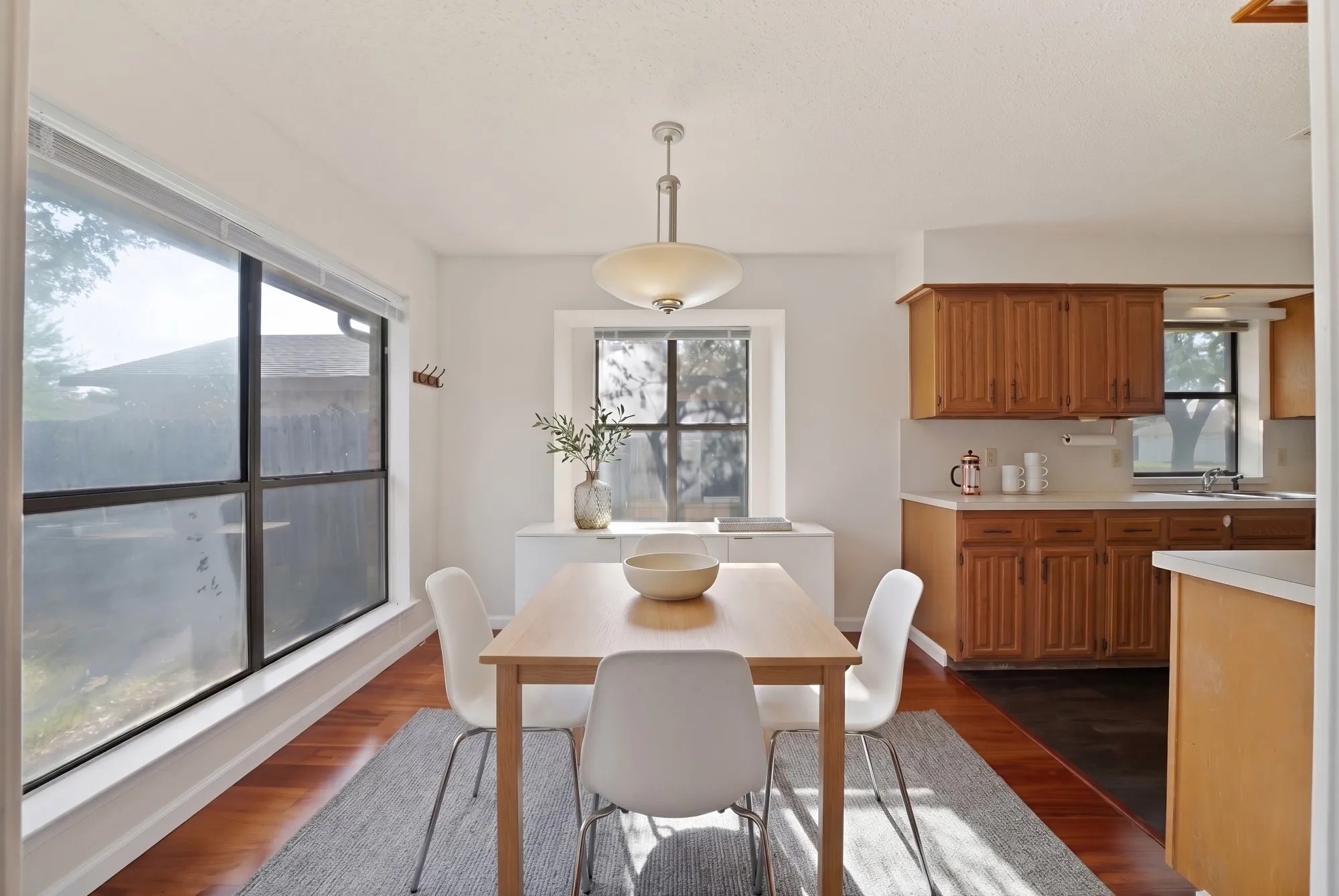 Virtually Staged Expansive windows, wood-finish flooring, recessed lighting, built-in cabinetry, and a contemporary ceiling fixture