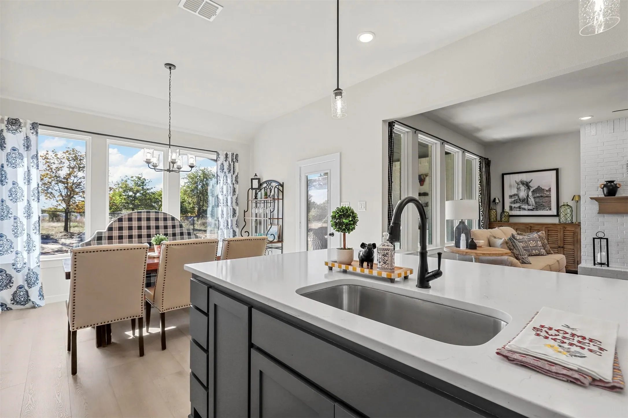 Kitchen island with a built-in undermount sink and a matte black faucet