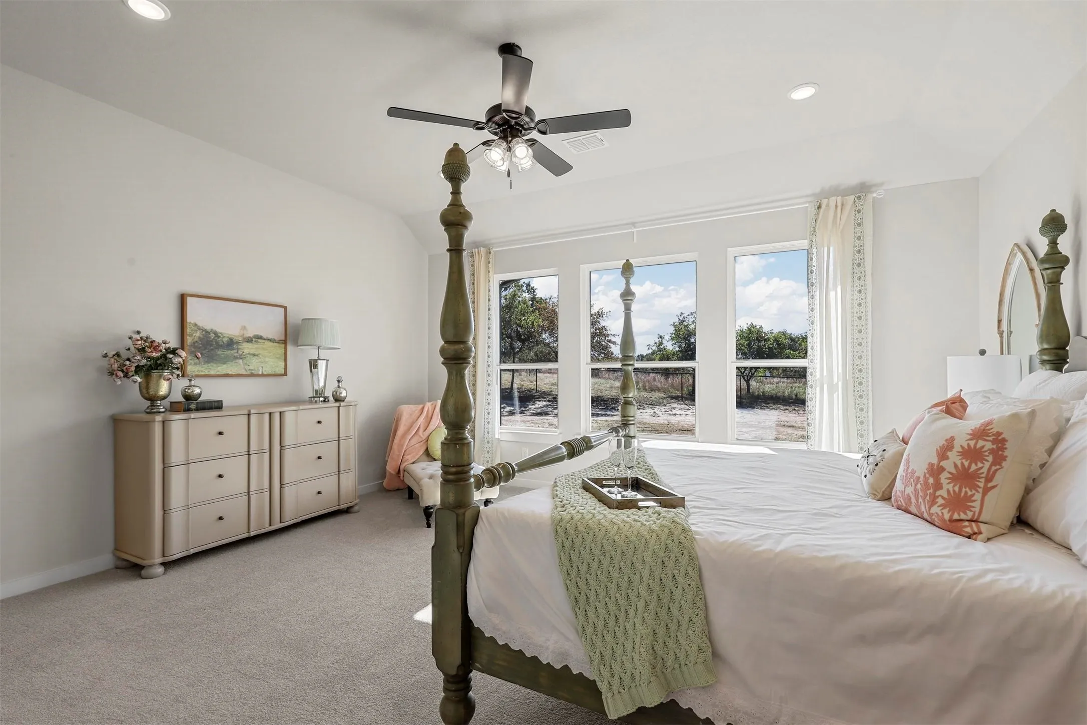 Multiple windows, ceiling fan with integrated lighting, recessed lighting, and carpeted flooring