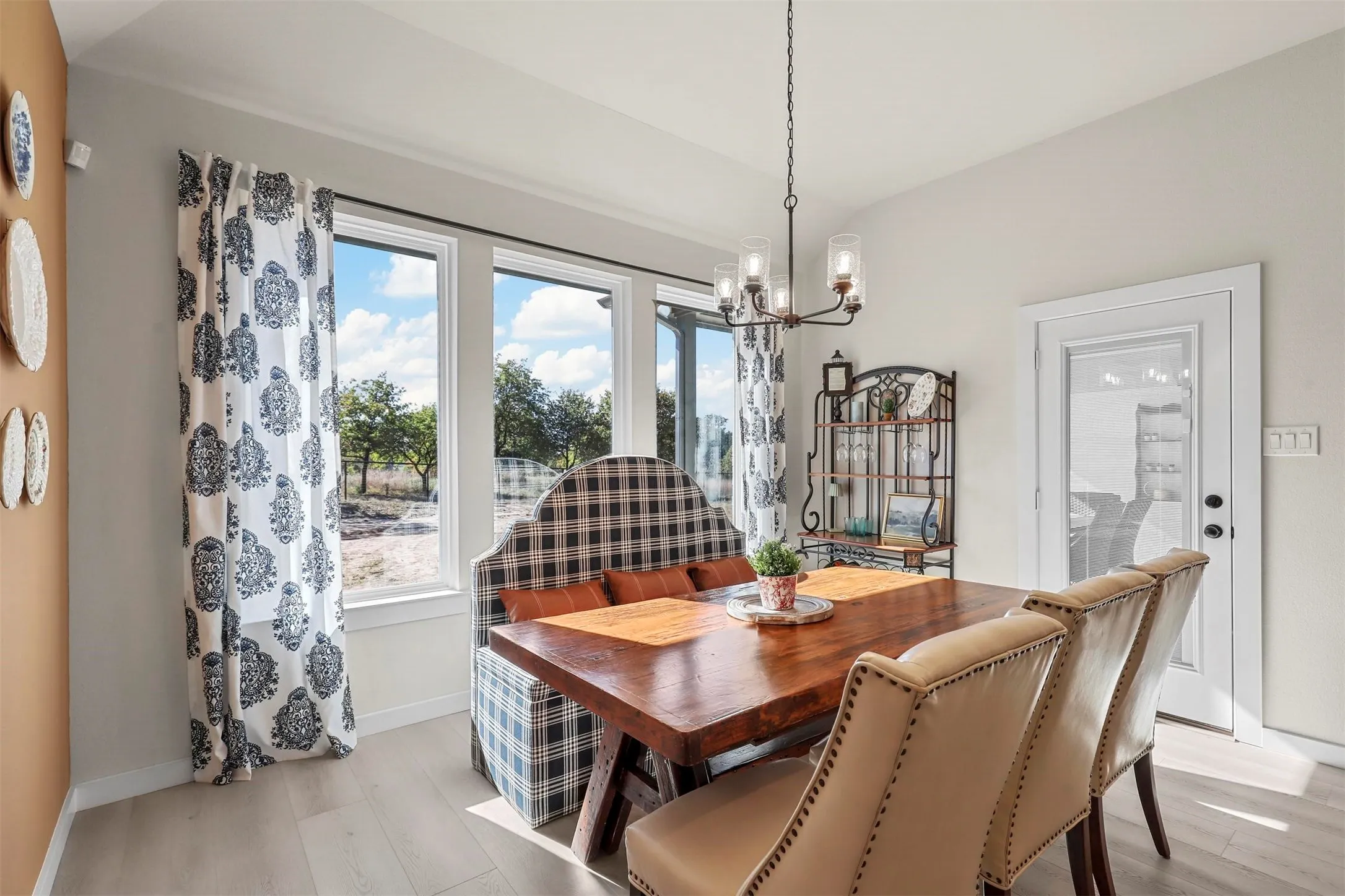 Recessed lighting, wood-finish flooring, glass-paned door, and a multi-pane window