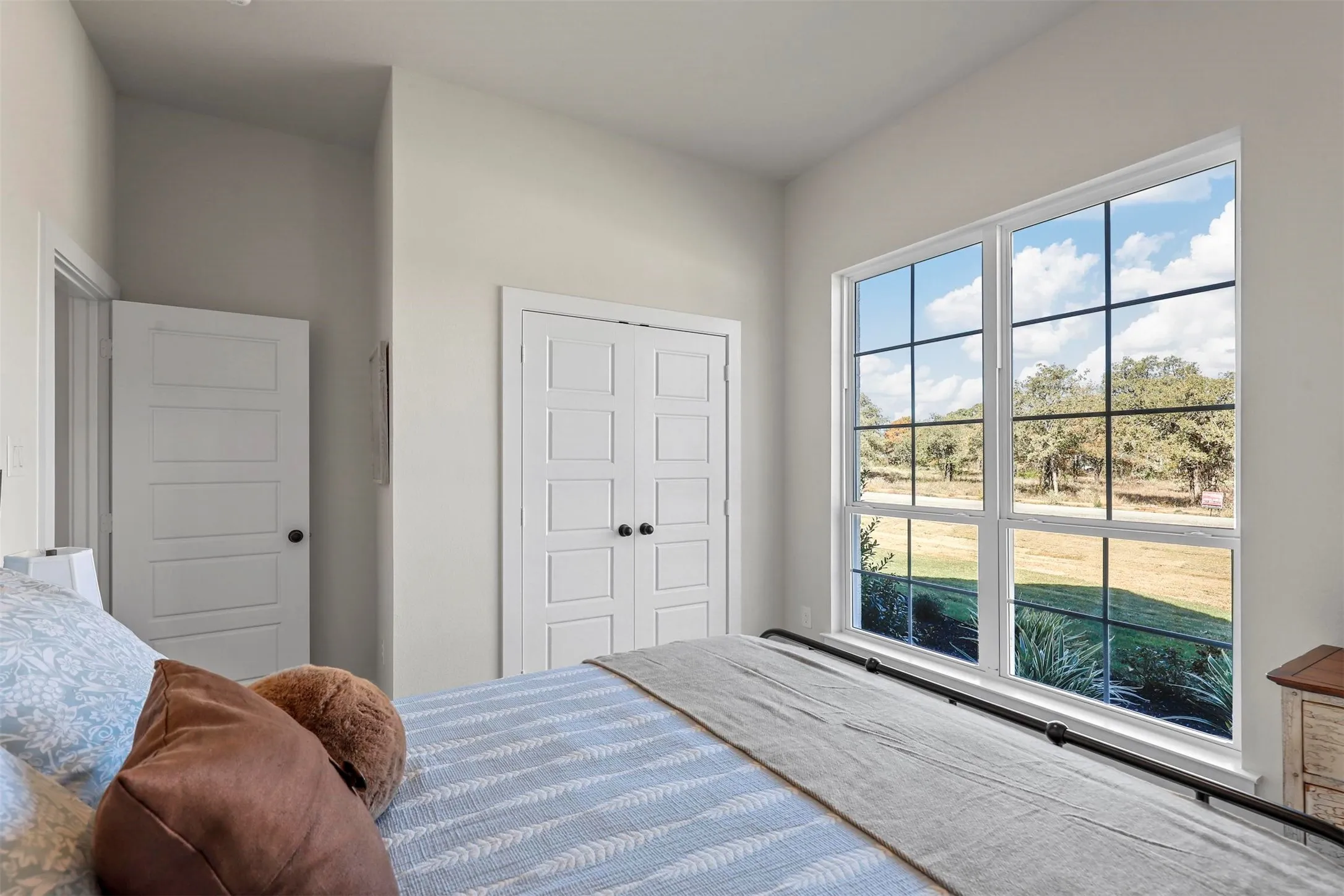Vaulted ceiling, paneled interior doors, bifold closet doors, and large grid windows