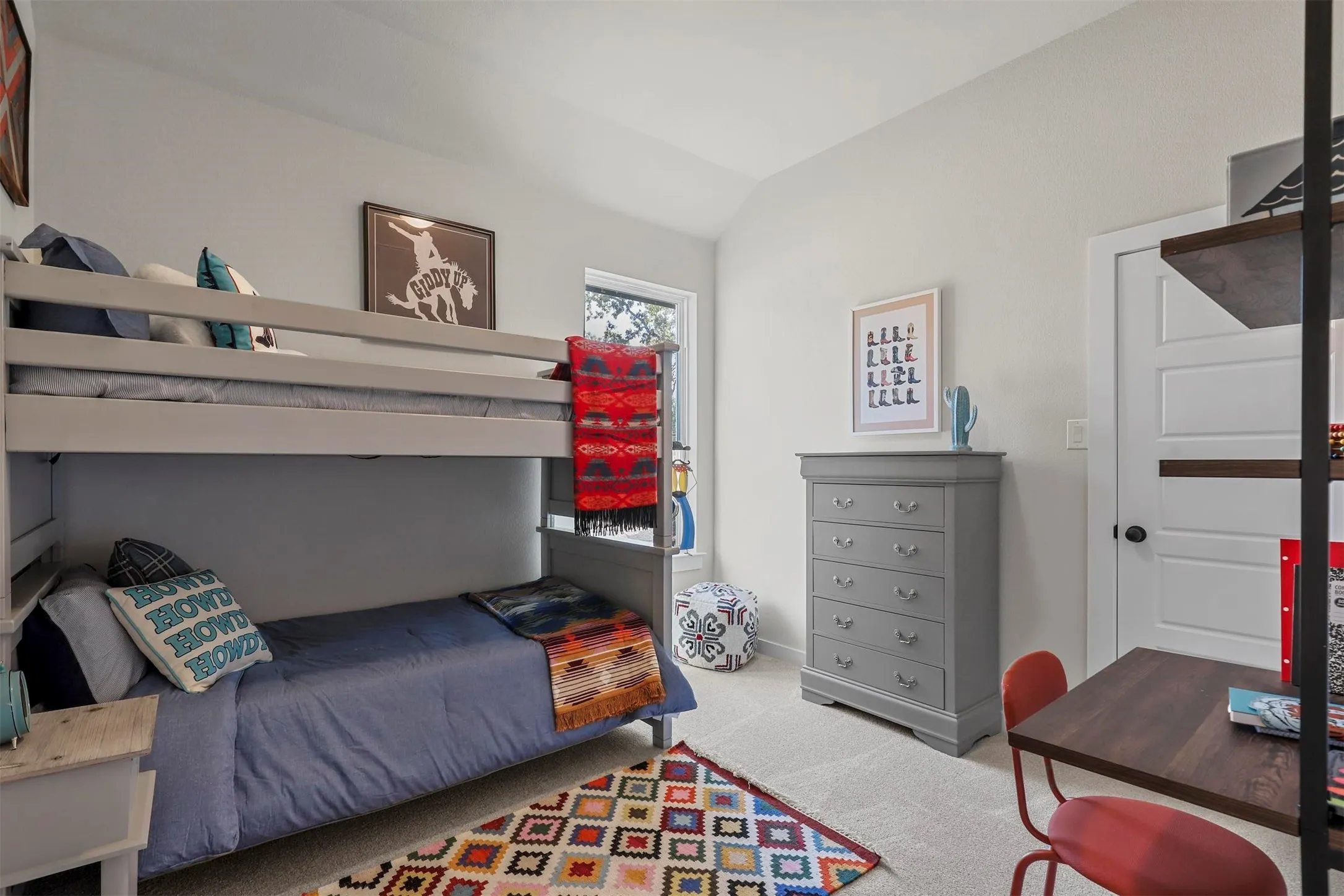 Carpeted room featuring a window, built-in bunk beds, and a white paneled door