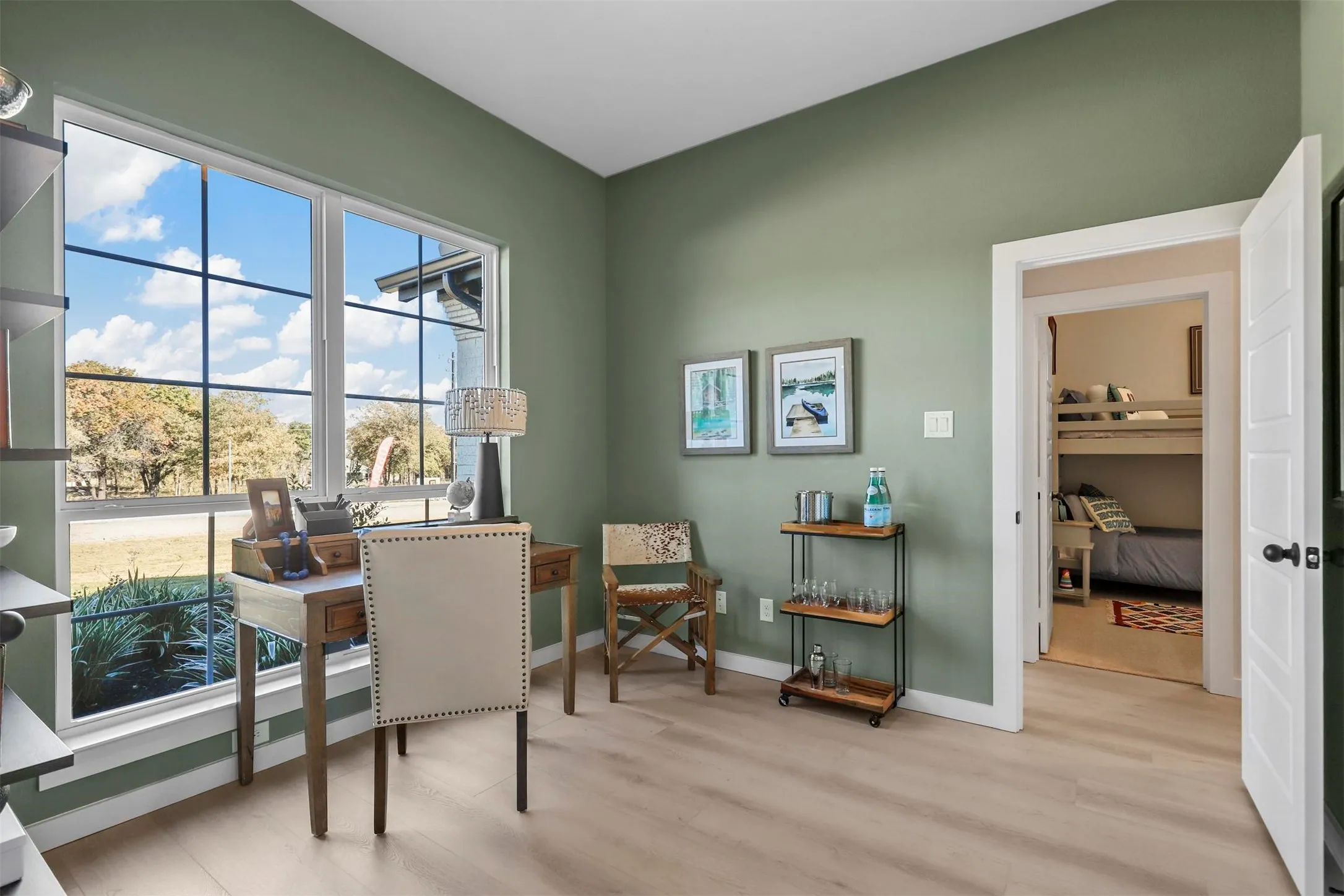 Spacious interior with neutral wall color and wood-finish flooring