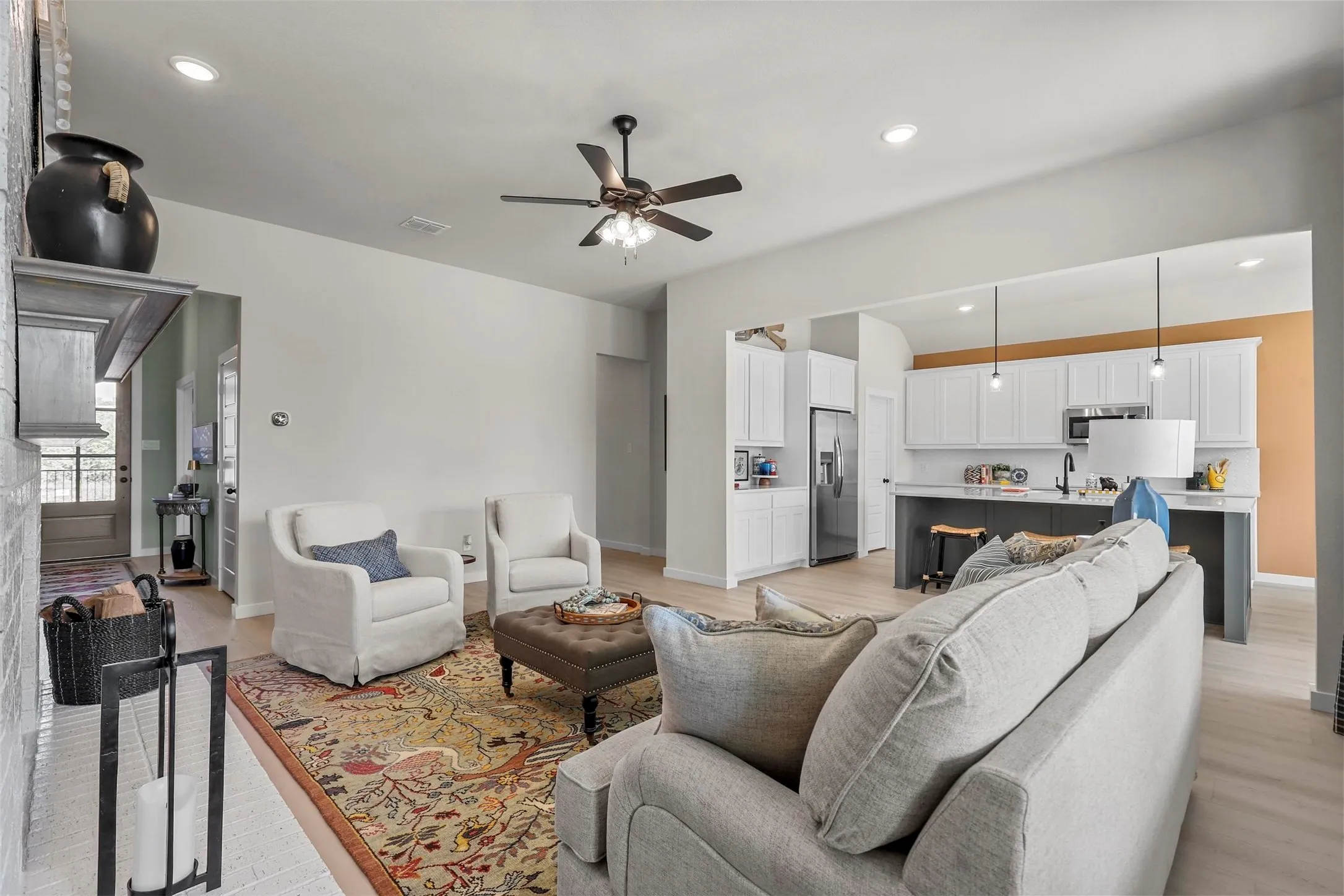 Open-concept living space featuring wood-finish flooring, recessed lighting, and a ceiling fan