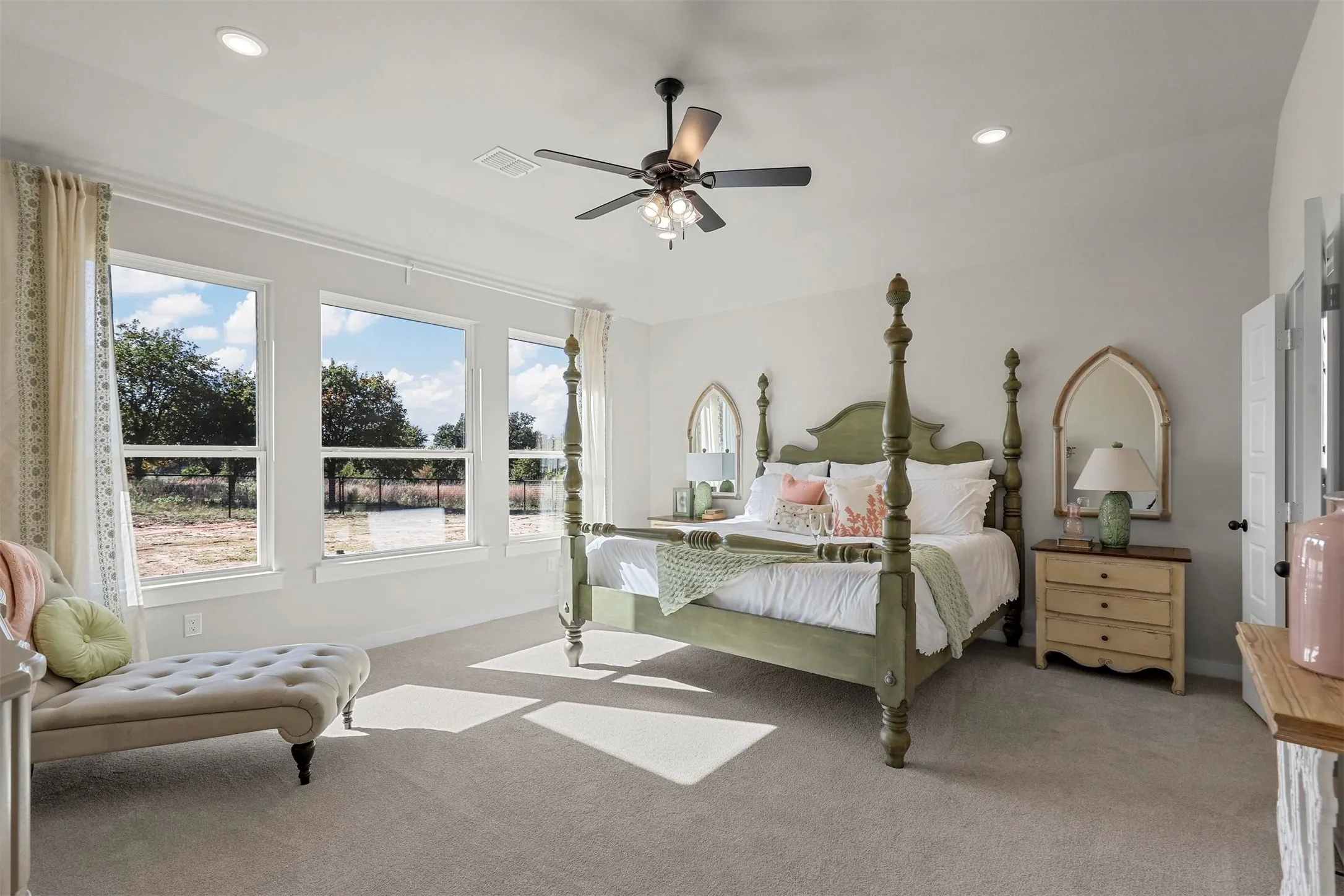 Recessed lighting, ceiling fan, and multiple windows with outdoor scenery