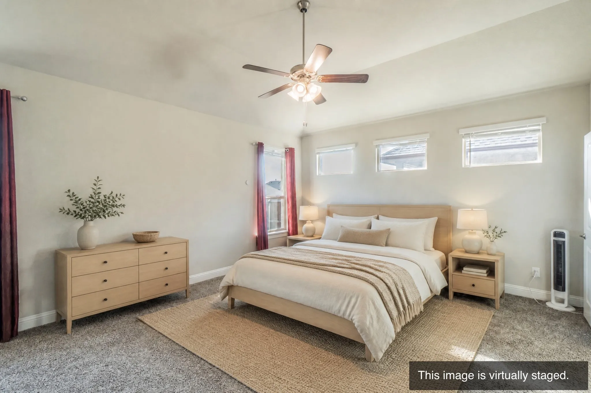 Spacious interior with neutral wall tones, textured carpeting, and a ceiling fan with integrated lighting