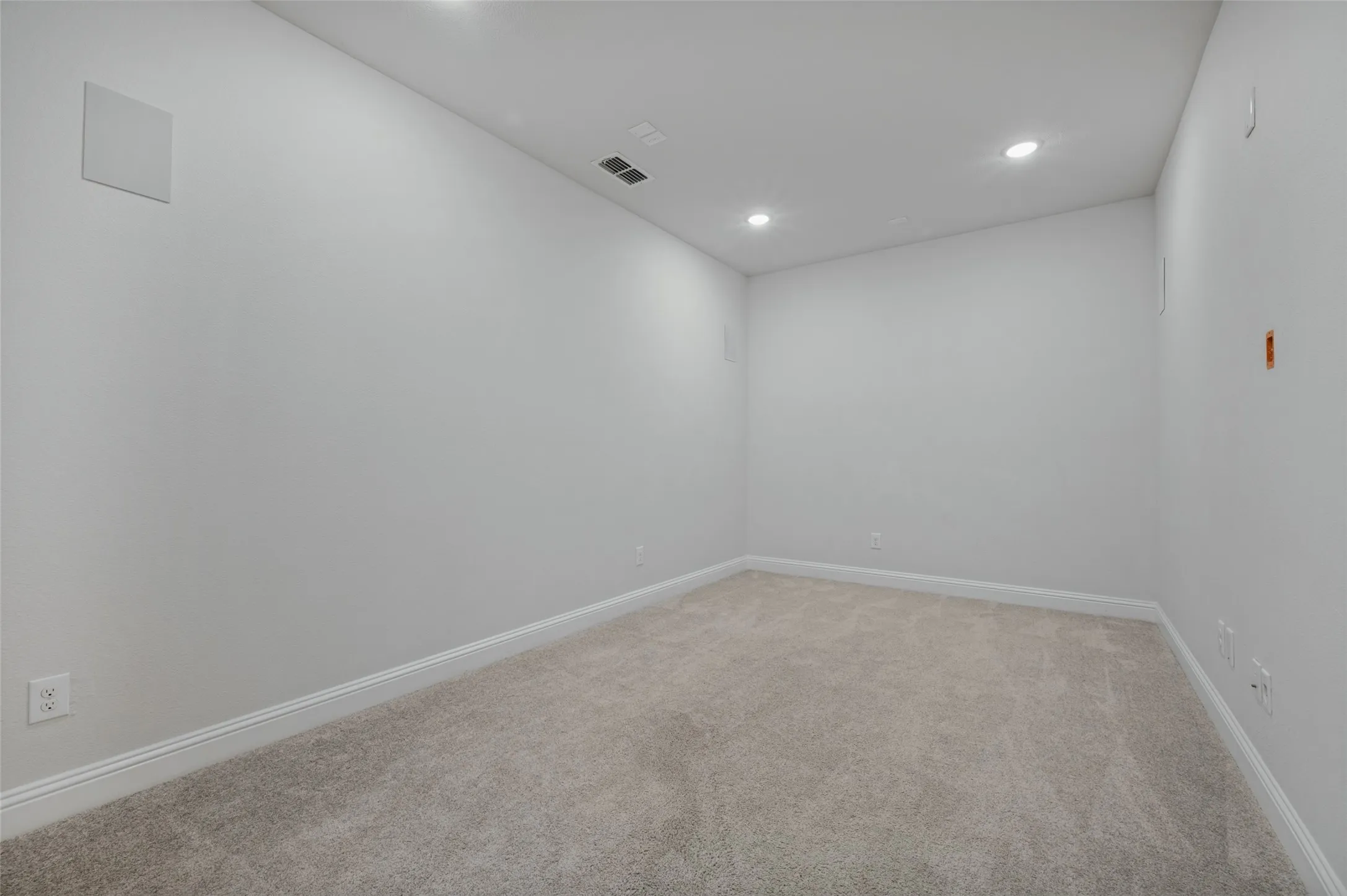 Media Room with recessed lighting, light-toned carpeting, white wall finishes, and ceiling-mounted sound speakers.