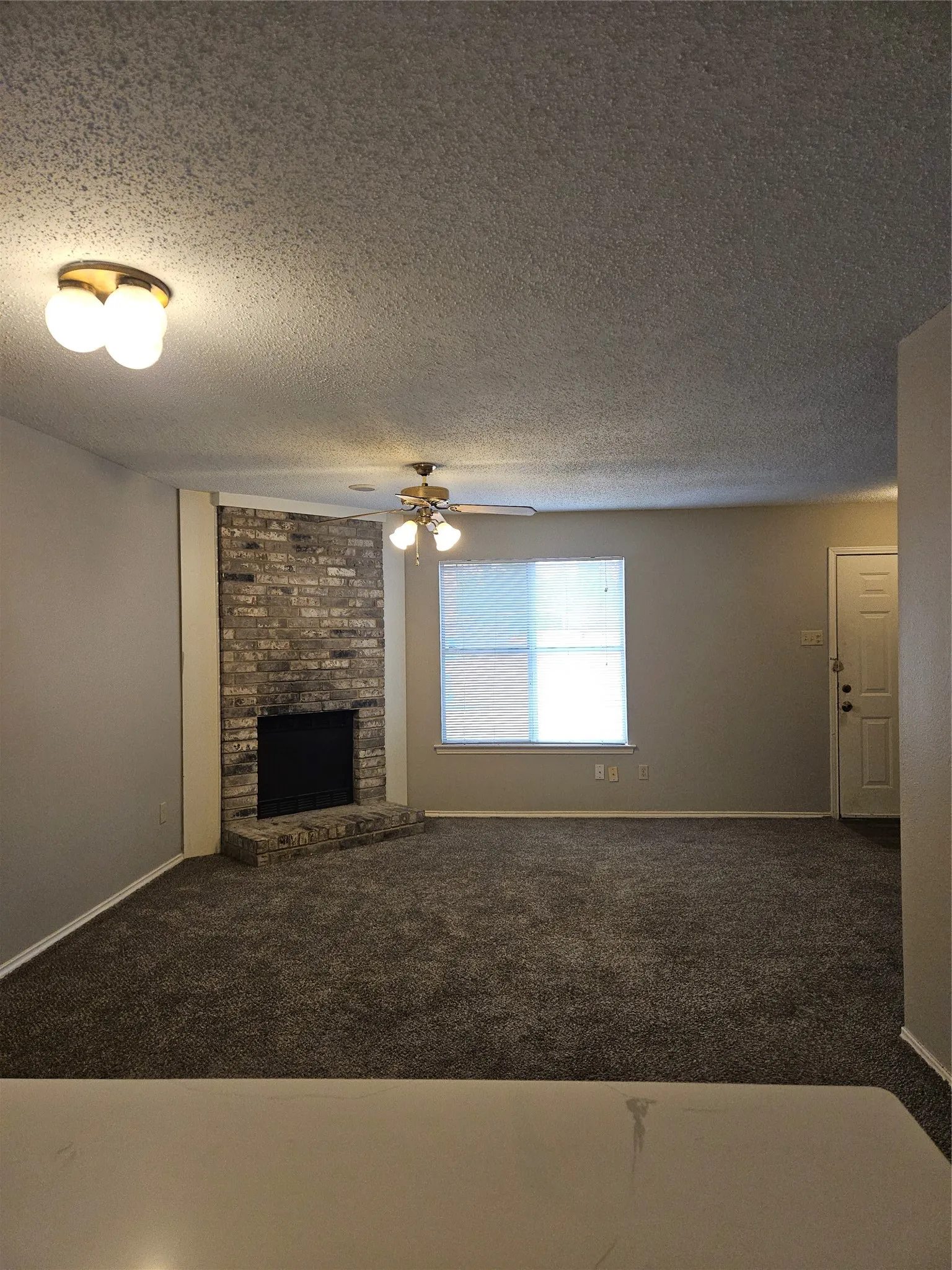 810 - From the kitchen, the view of dining, living, hearth, and front door.