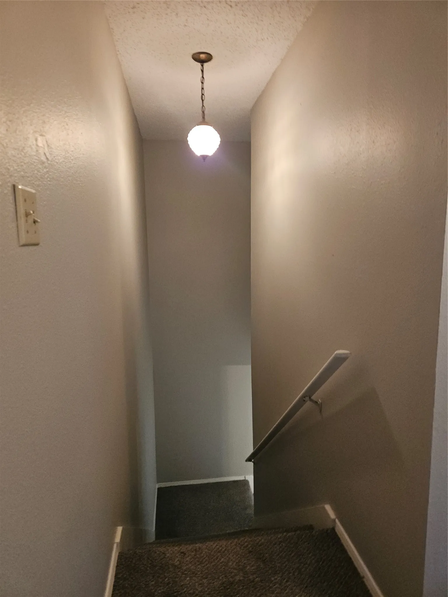 810 - Stairs down to landing with light above.