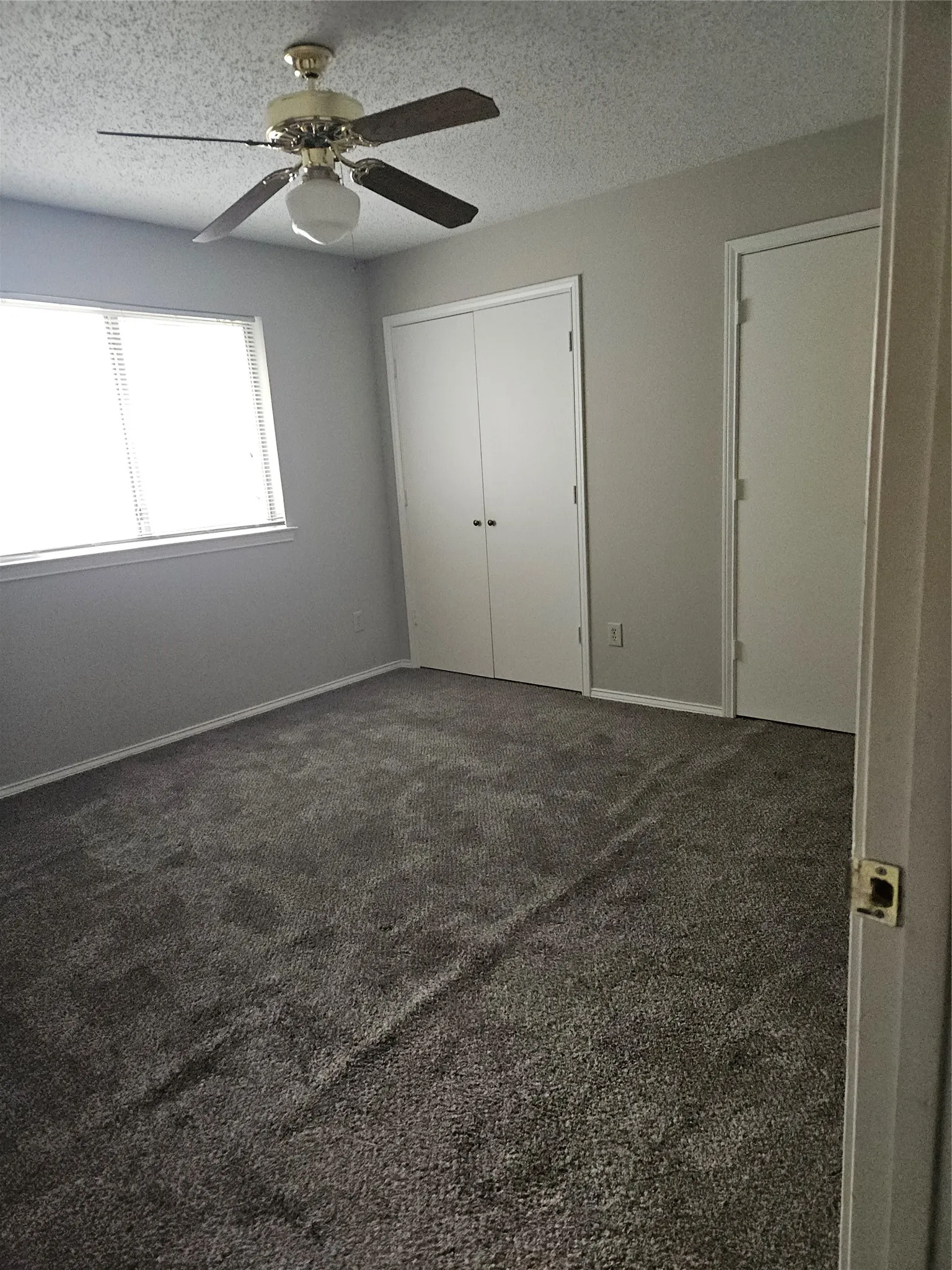 810 - Bedroom with two closets and ceiling fan with light.