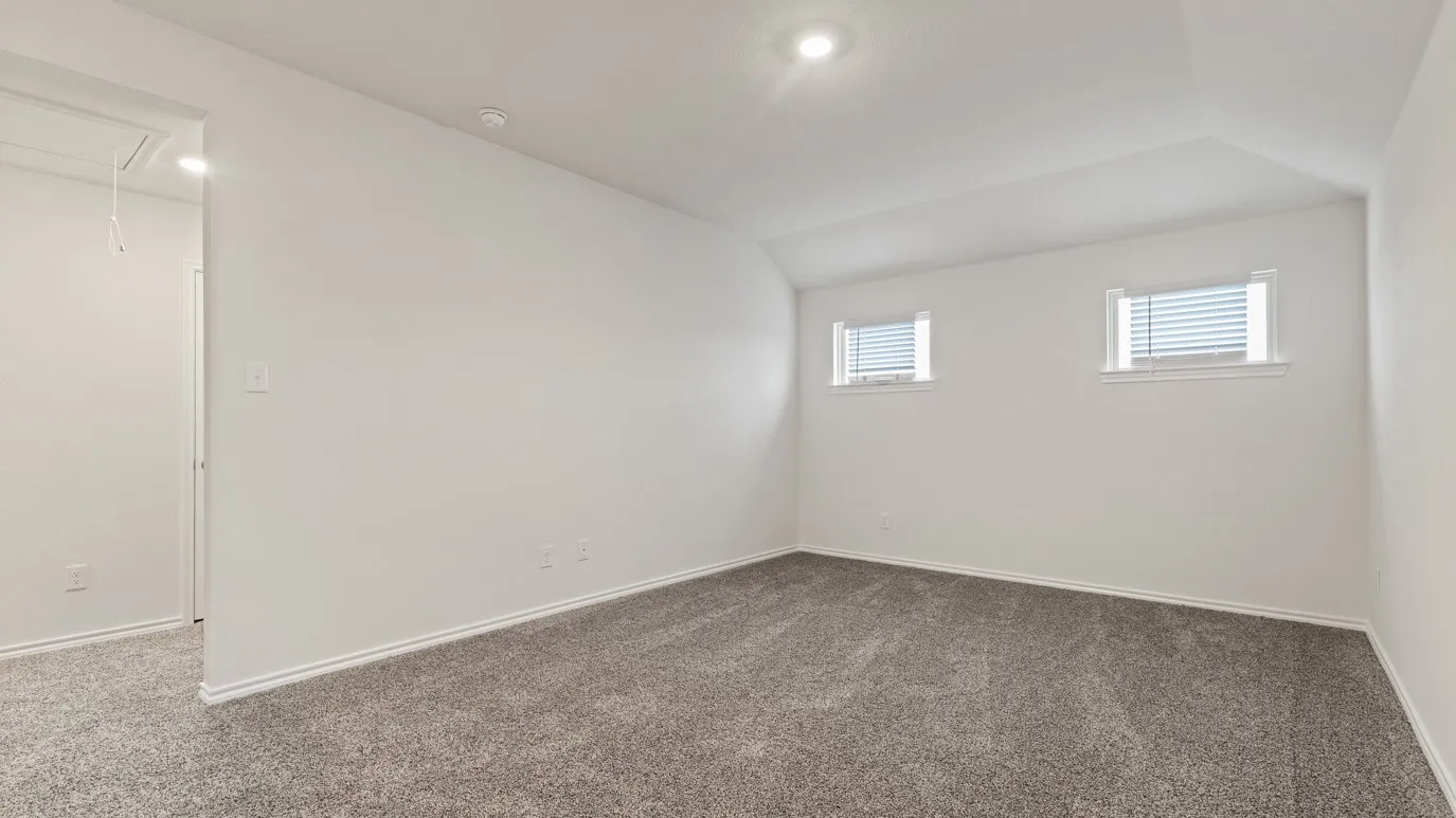 Carpeted room with white walls, two windows with blinds, and recessed lighting