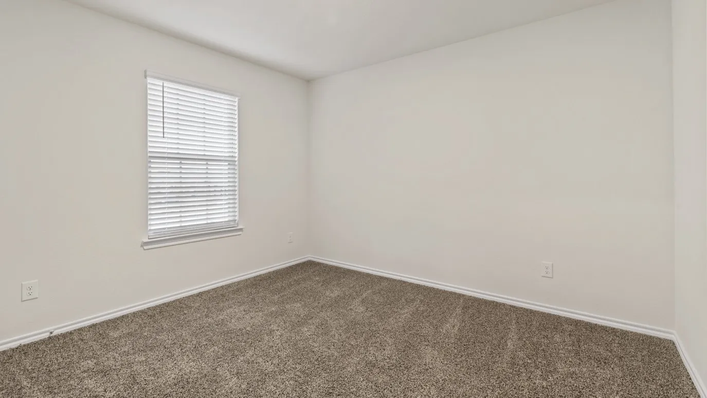 Neutral-toned carpeting, light wall paint, and a window with blinds