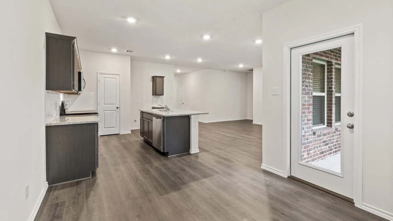 Recessed lighting, wood-finish flooring, white walls, and a full-light exterior door