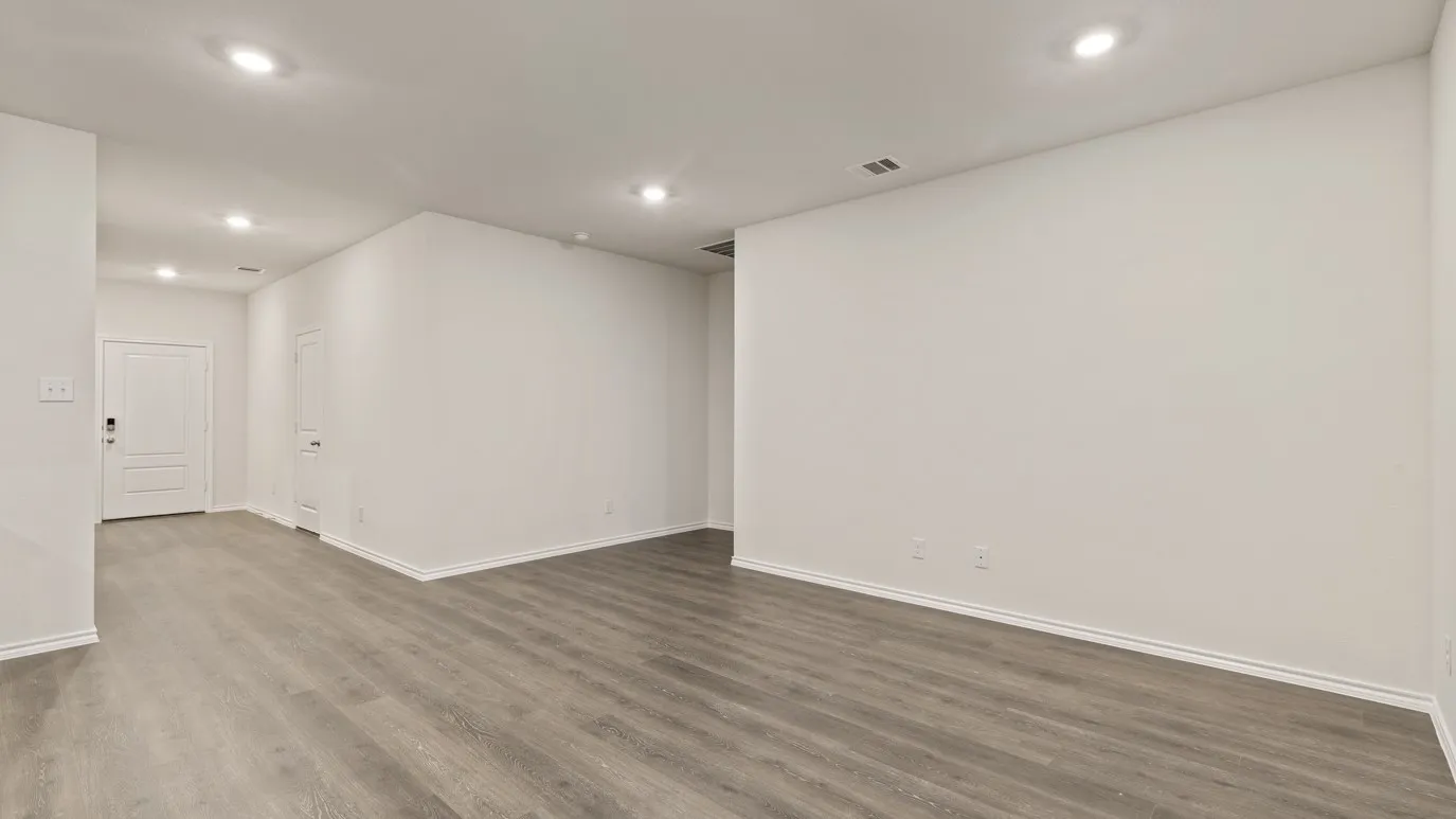 Recessed lighting, wood-finish flooring, white trim, and white interior doors