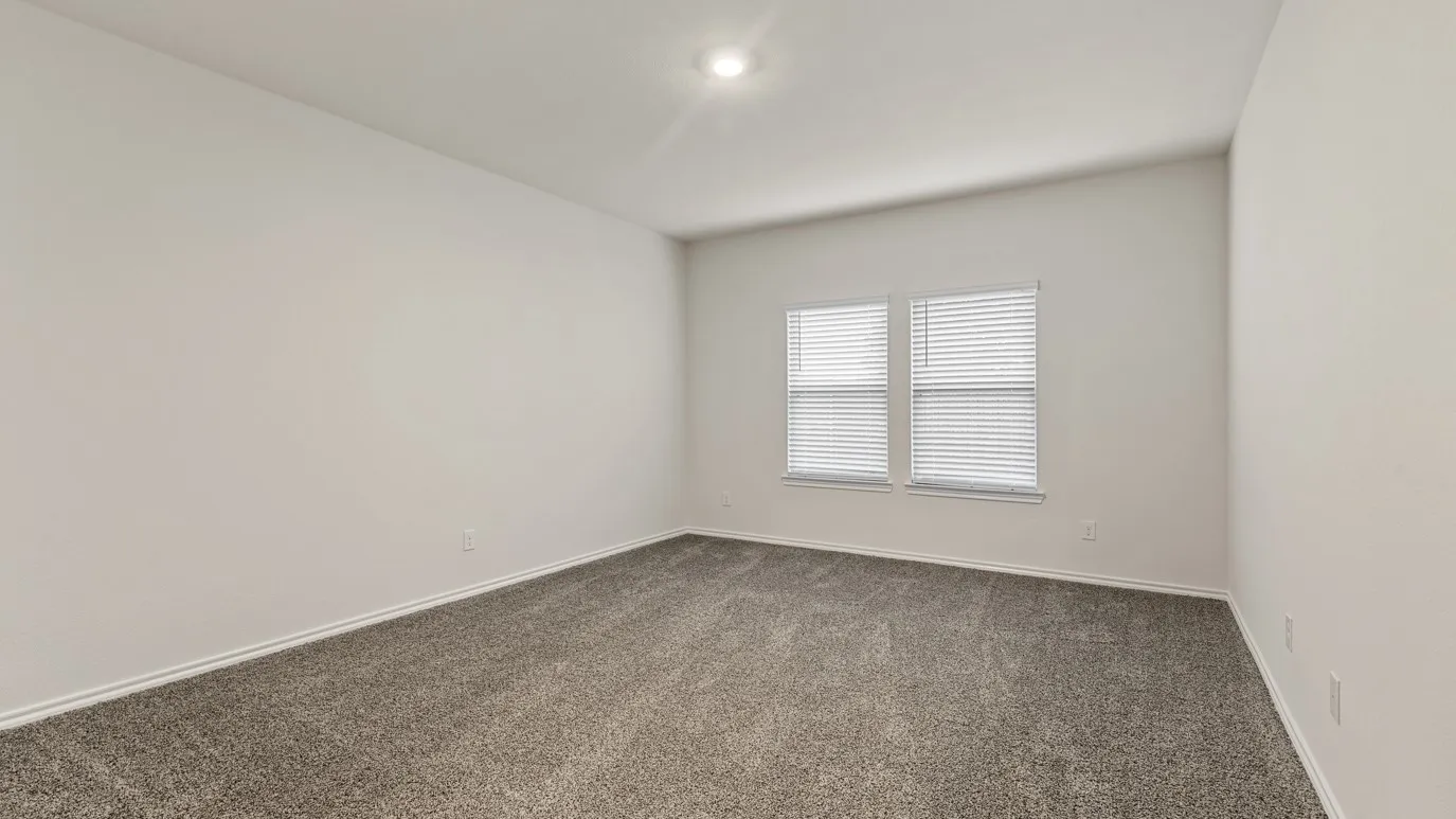 Recessed ceiling lighting, dual windows with blinds, light-toned wall paint, and gray carpeting