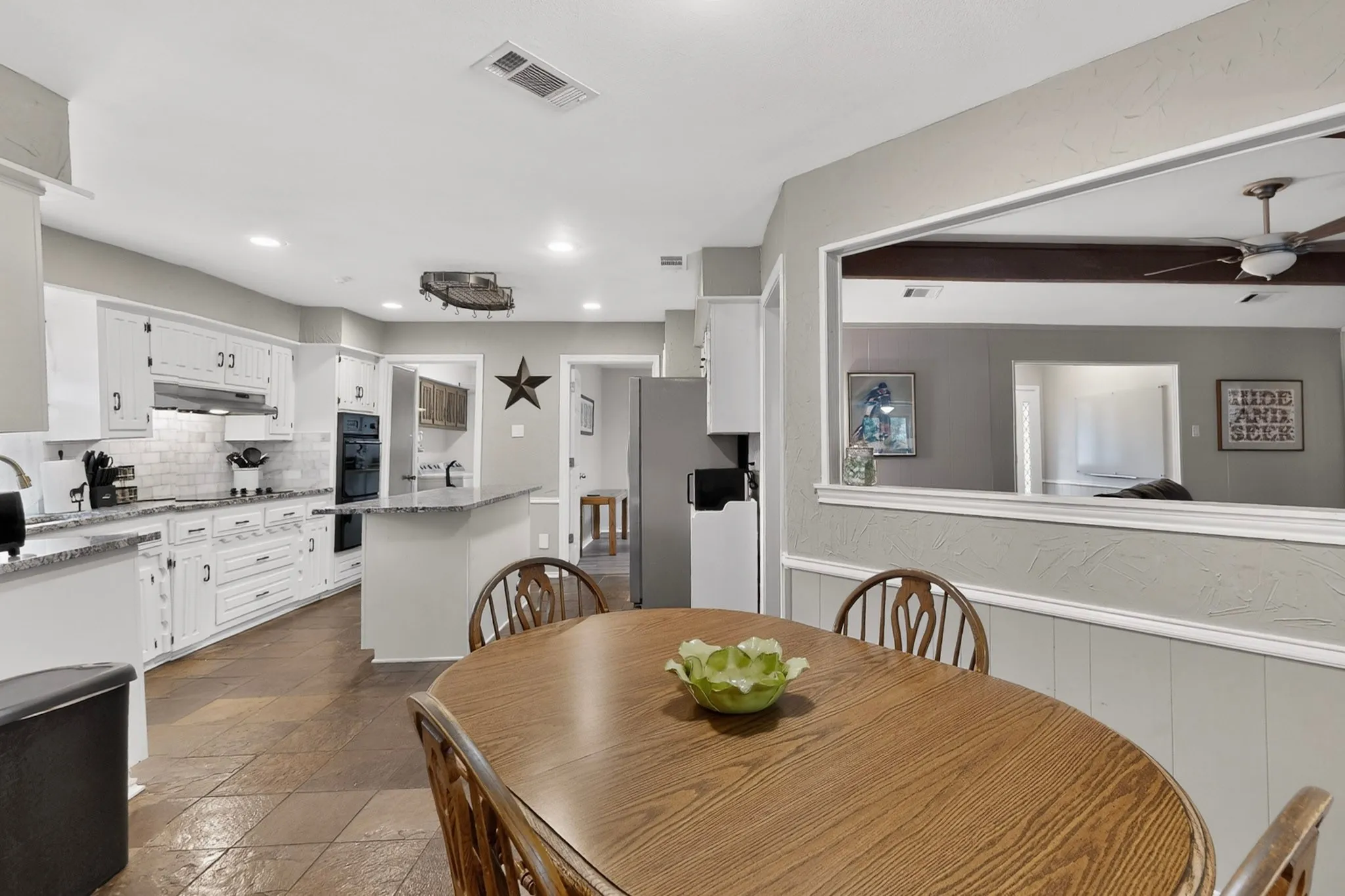 Kitchen featuring white cabinetry, subway tile backsplash, built-in double oven, and recessed lighting