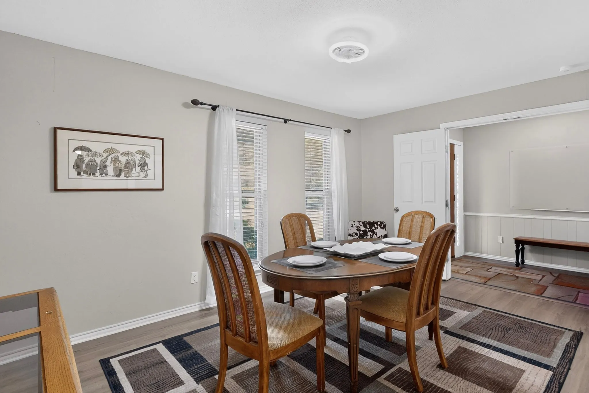 Recessed lighting, light gray wall paint, and wood-finish flooring